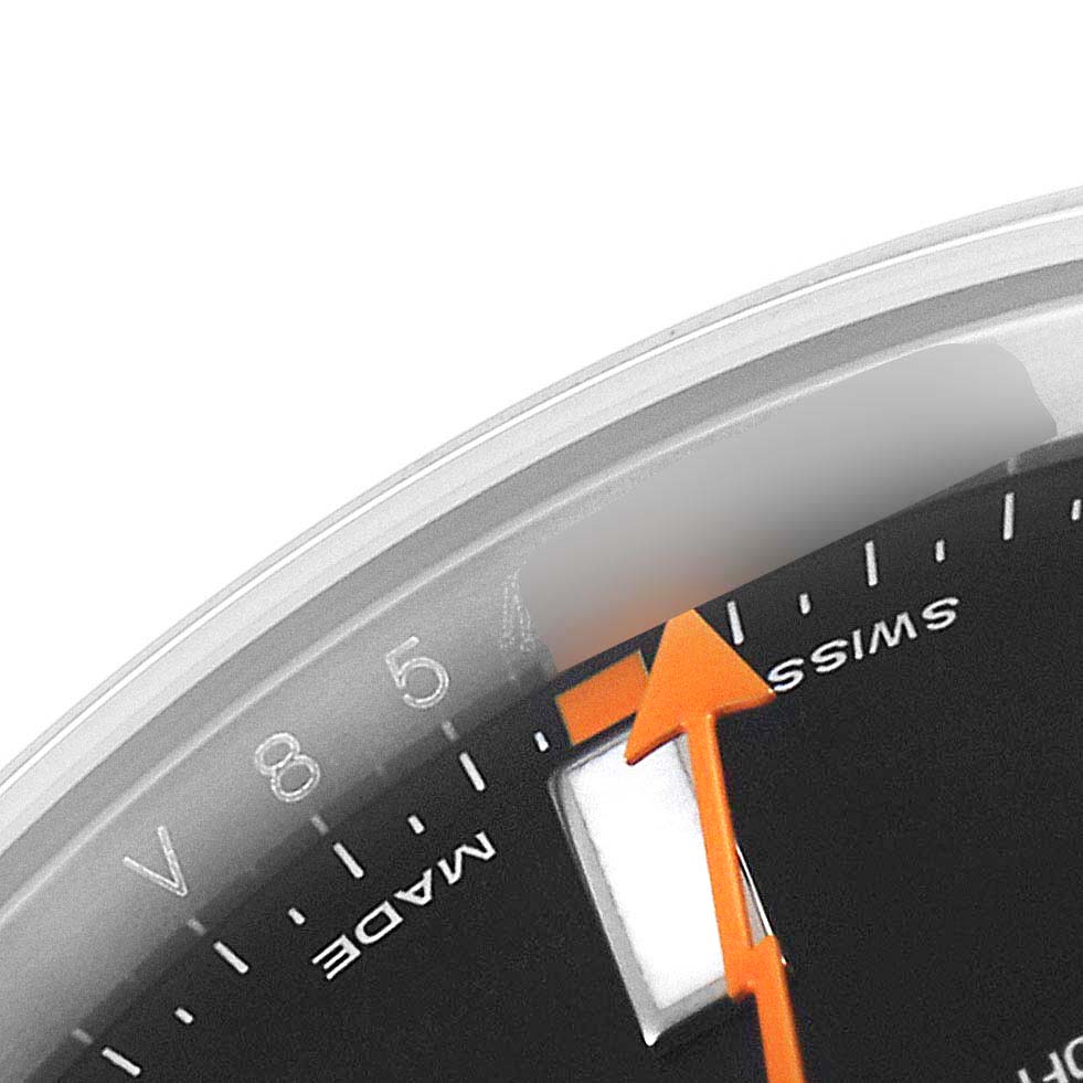 The image shows a close-up of the Milgauss model by Rolex, highlighting the orange seconds hand, part of the dial, and "Swiss Made" text.