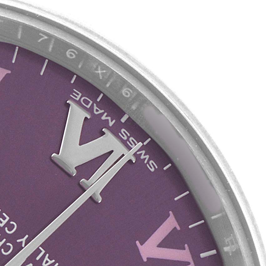 The image shows a close-up of the dial and bezel of a Rolex Oyster Perpetual 177200 Women's Stainless Steel Purple Dial, featuring a purple dial and Roman numerals.