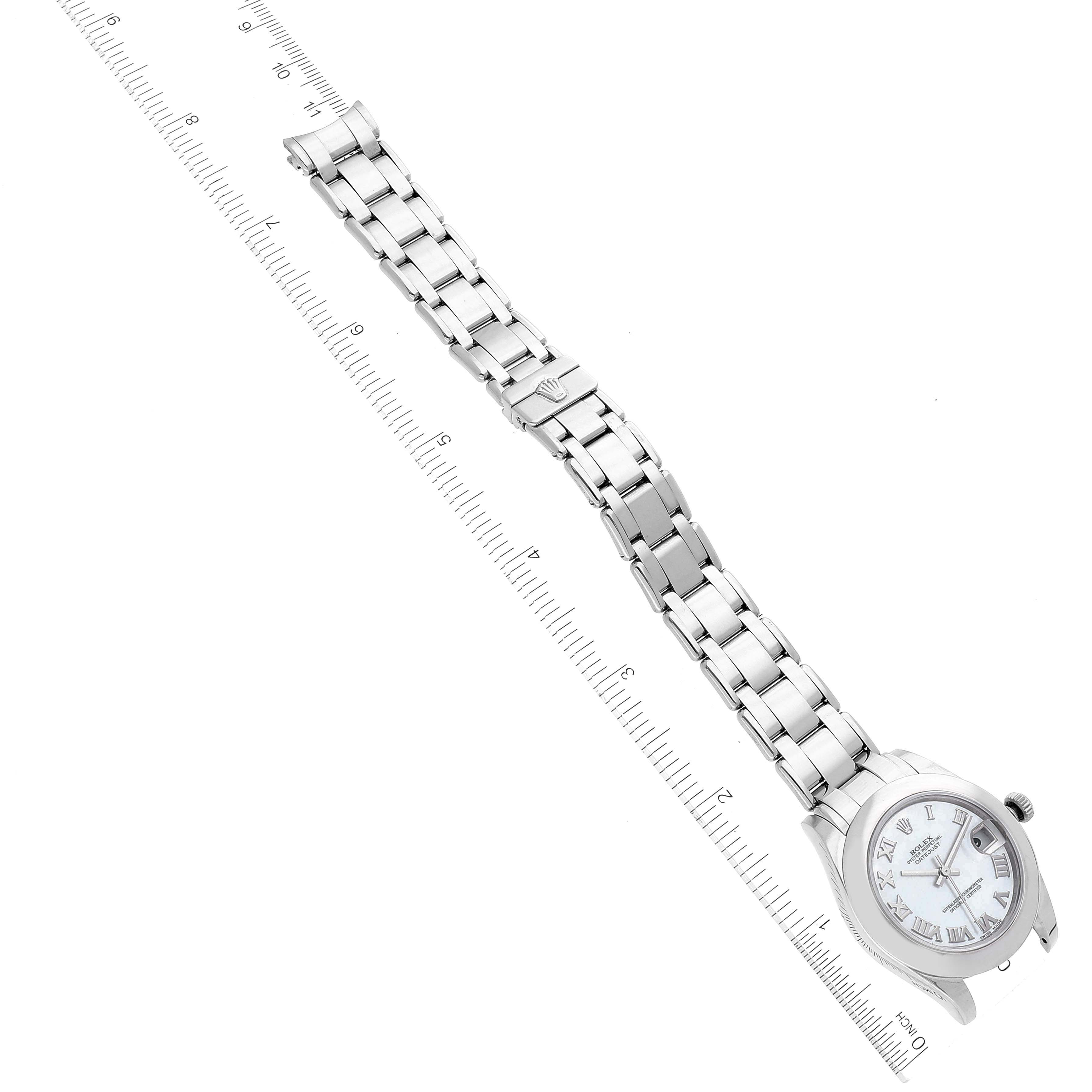 The Rolex Pearlmaster 81209 Women's White Gold Mother of Pearl Dial watch is shown from a top angle, displaying the full bracelet and face alongside a ruler for scale.