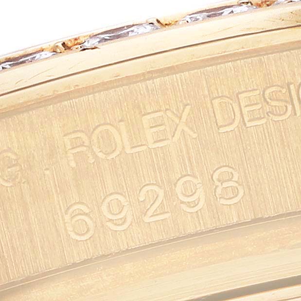 The image shows the engraved side of a Rolex Pearlmaster 69298 Women's Yellow Gold Mother of Pearl Dial 69298 Women's Yellow Gold Mother of Pearl Dial, highlighting the model number.