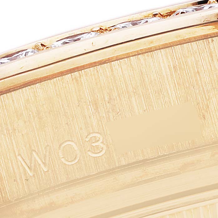 The image shows a close-up angle of the Rolex Pearlmaster 69298 Women's Yellow Gold Mother of Pearl Dial 69298 Women's Yellow Gold Mother of Pearl Dial watch's side, highlighting its engraved serial number and part of the bezel.