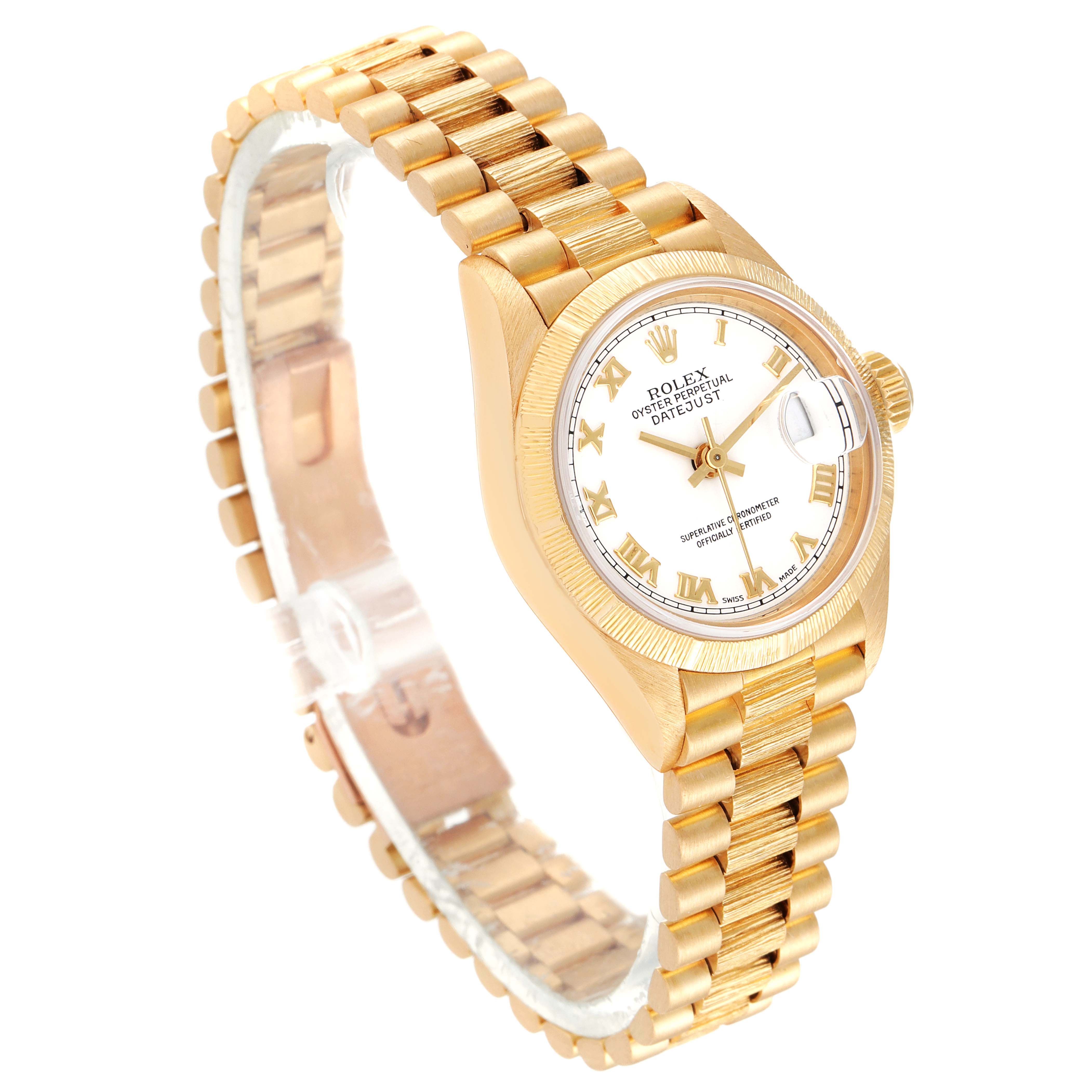 The image shows a Rolex President 69278 Women
s Yellow Gold White Dial 69278 Women
s Yellow Gold White Dial model watch at an angle, highlighting its gold bracelet, white dial, and date function.