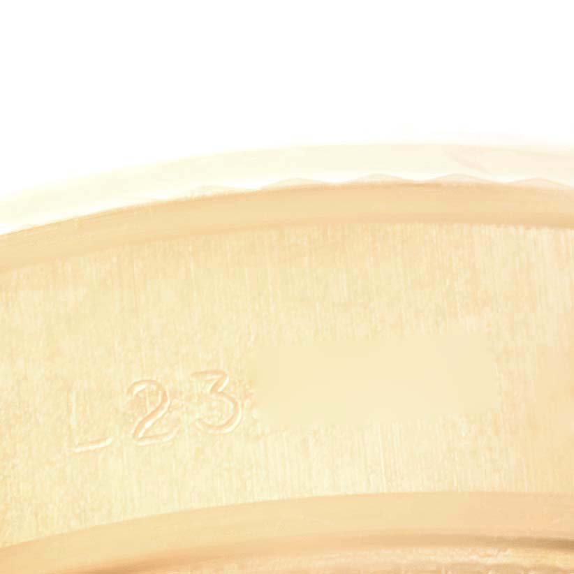 The image shows a close-up angle of the Rolex President 69178 Women
s Yellow Gold Champagne Dial 69178 Women
s Yellow Gold Champagne Dial model watch’s inner band with visible engravings.