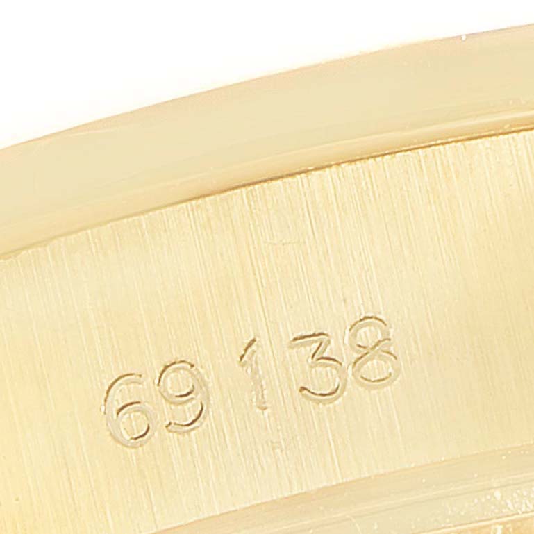 This close-up image shows part of the serial number engraved on the metal case of a Rolex President 69138 Women
s Yellow Gold Champagne Dial 69138 Women
s Yellow Gold Champagne Dial model.