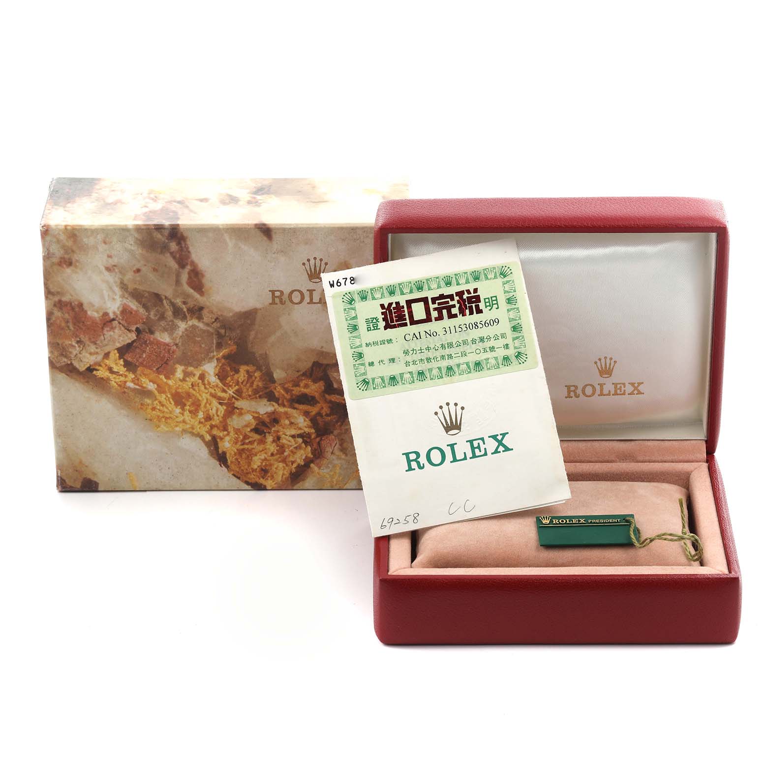 The image shows a Rolex President 69258 Women's Yellow Gold Champagne Dial 69258 Women's Yellow Gold Champagne Dial box, booklet, and tag from an elevated angle.