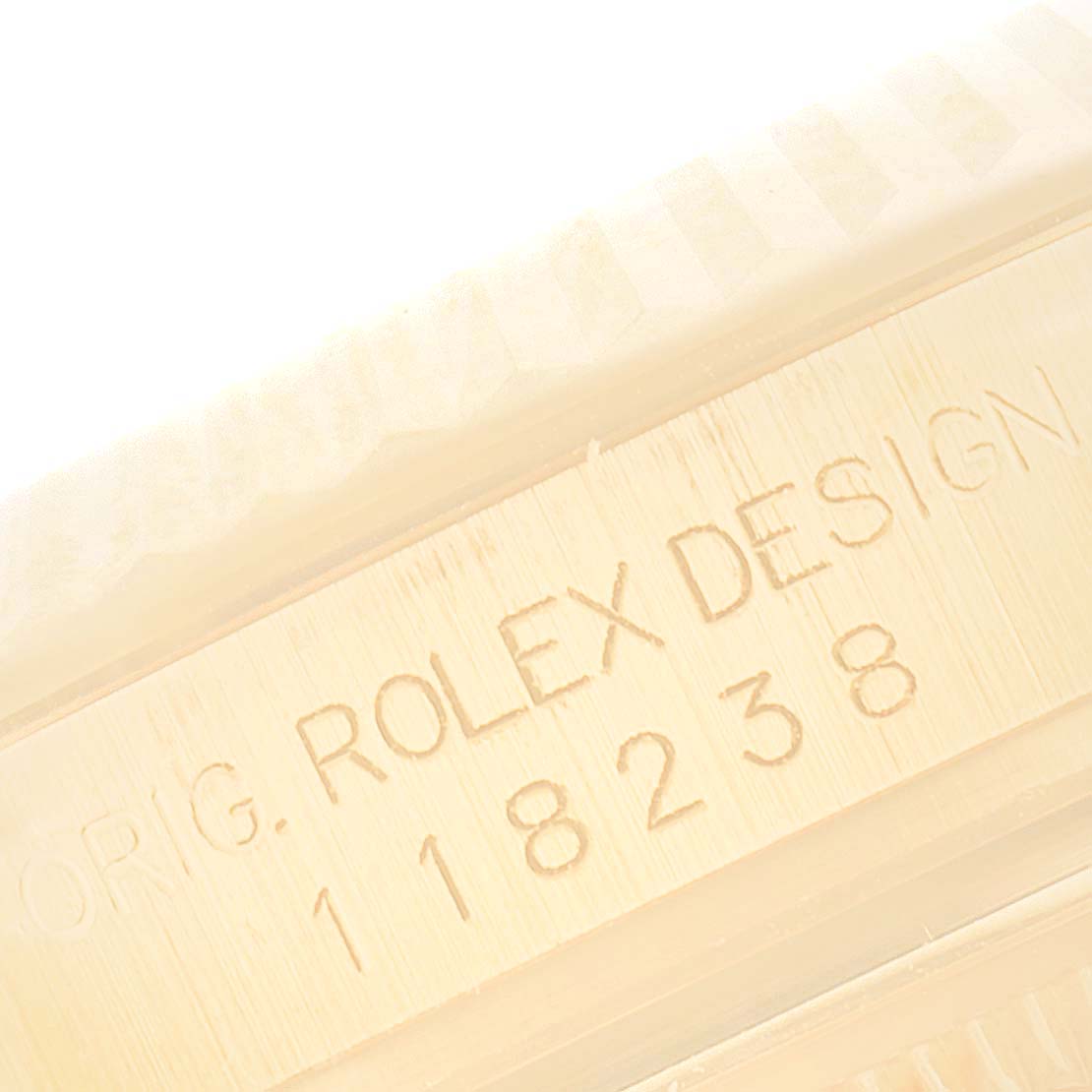 A close-up shot of the Rolex President 118238 Men
s Yellow Gold Champagne Dial 118238 Men
s Yellow Gold Champagne Dial model shows its case with the engraved design number 118238.