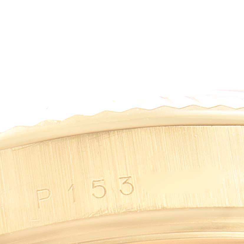The image shows a close-up of the side of a Rolex President 118238 Men
s Yellow Gold Champagne Dial 118238 Men
s Yellow Gold Champagne Dial model watch, displaying part of the bezel and engraved serial number.