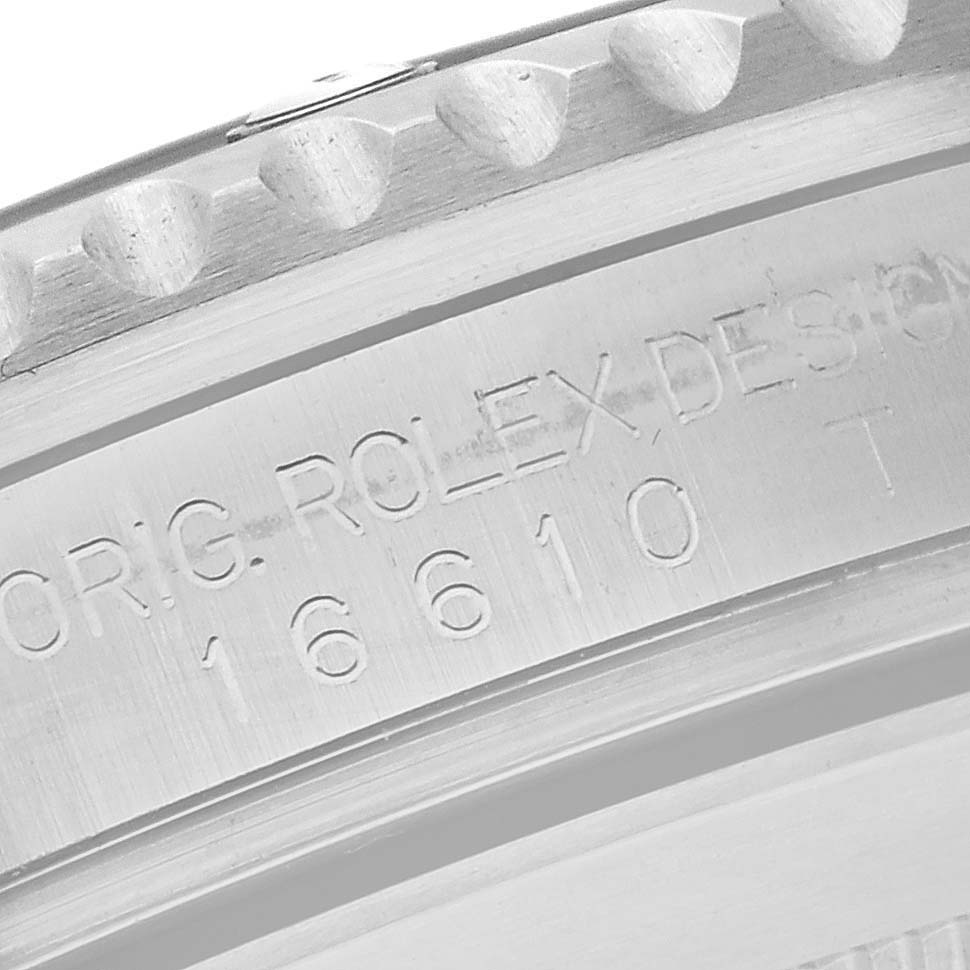 The image shows a close-up of the engraved case back of a Rolex Submariner 16610 Men
s Stainless Steel Black Dial 16610 Men
s Stainless Steel Black Dial, highlighting the model number.