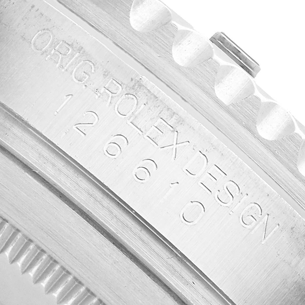 The image shows a close-up of the serial engraving on the case side of a Rolex Submariner 126610LN Men's Stainless Steel Black Dial watch.