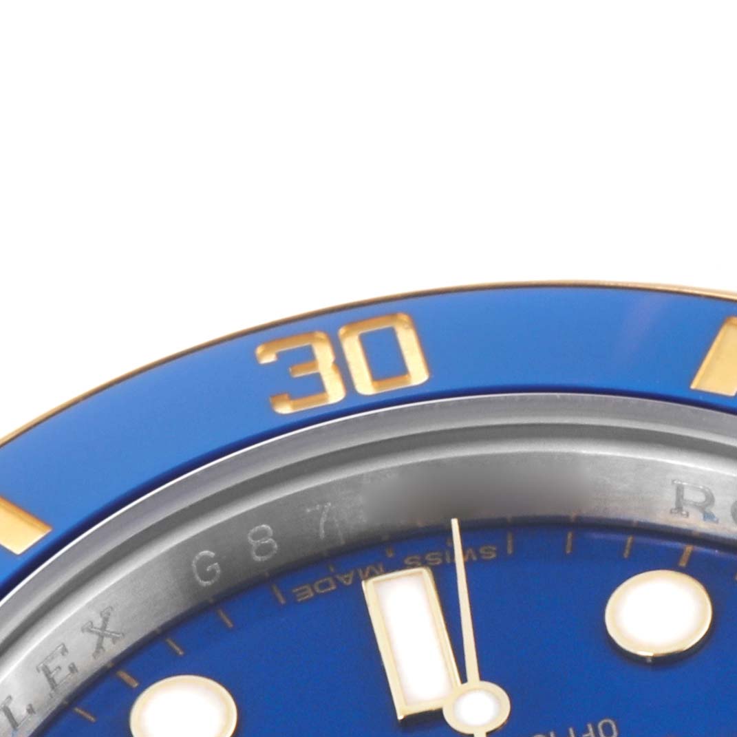 This close-up angle shows the blue and gold bezel, part of the dial, and hour markers of the Rolex Submariner 116613 Men's Steel and Gold (two tone) Blue Dial.