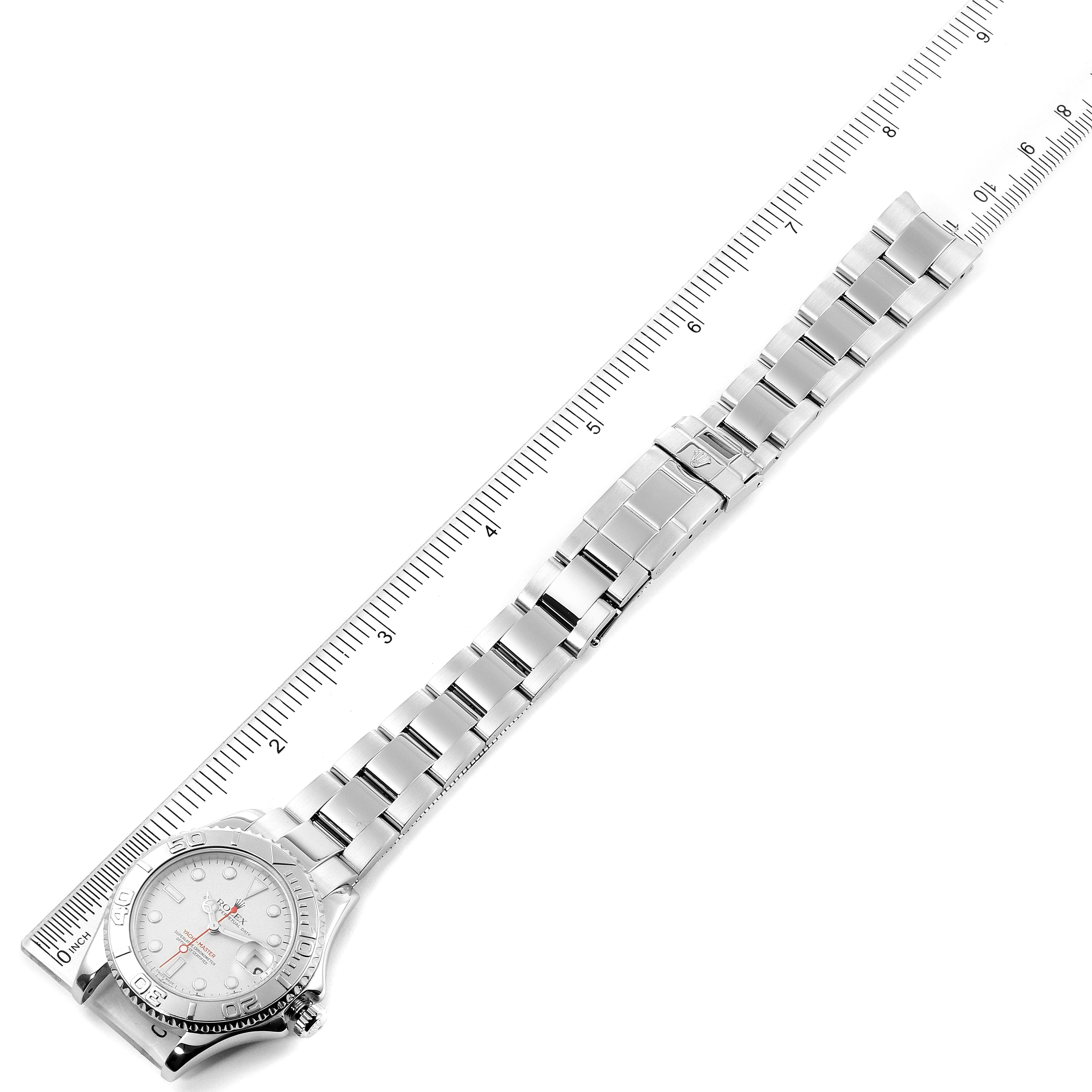 The image shows a top-down view of the Rolex Yacht-Master 168622 Men
s Stainless Steel Silver Dial 168622 Men
s Stainless Steel Silver Dial watch, displaying its face, bezel, and full metal bracelet against a ruler.