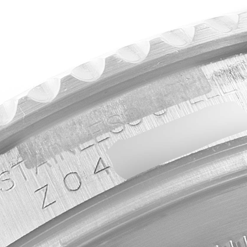 This close-up image shows the engraved details on the bezel and case of a Rolex Yacht-Master 16622 Men
s Stainless Steel Silver Dial 16622 Men
s Stainless Steel Silver Dial watch.
