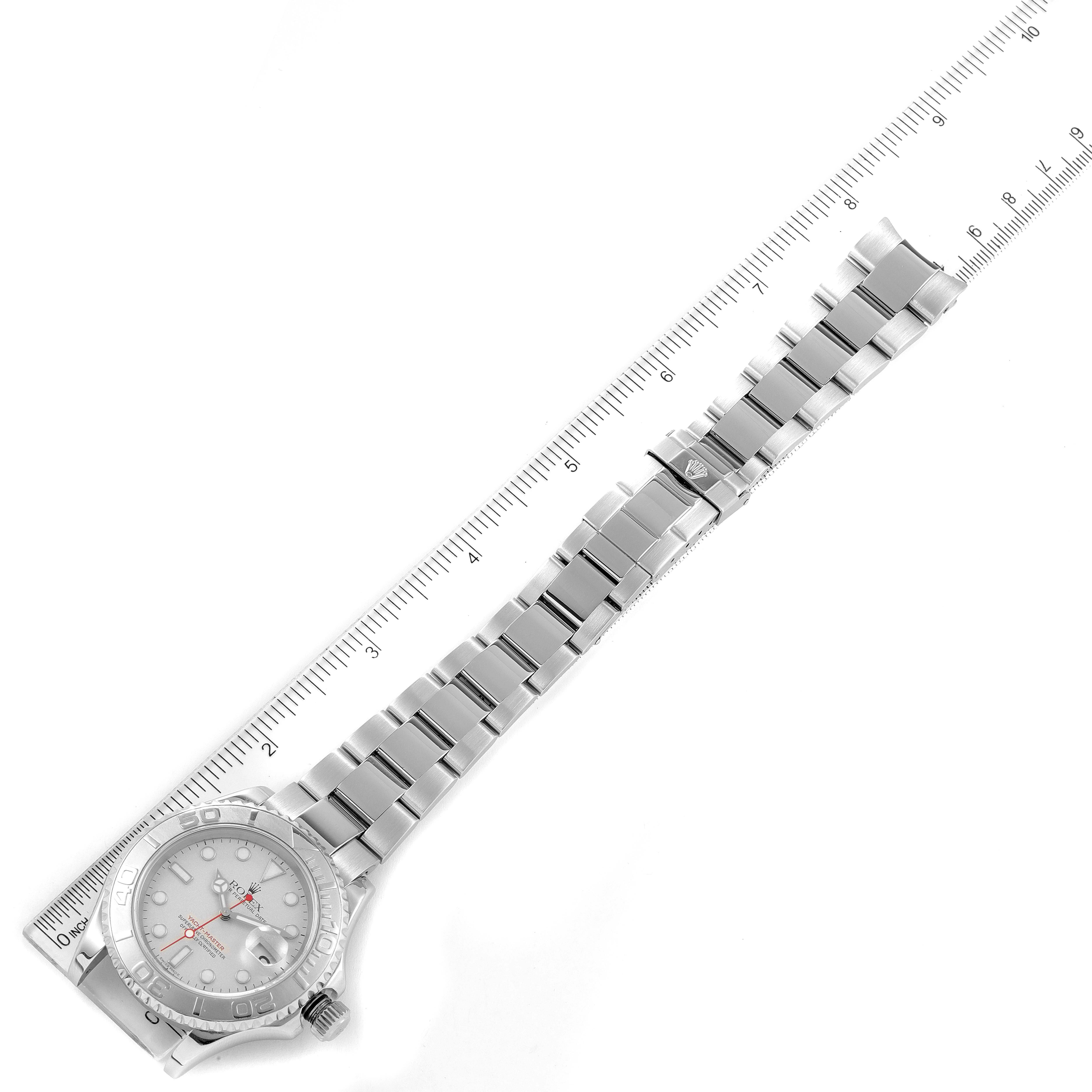 The image shows a top-down angle of a Rolex Yacht-Master 16622 Men
s Stainless Steel Silver Dial 16622 Men
s Stainless Steel Silver Dial watch, displaying its bracelet, case, and dial alongside a measuring scale.