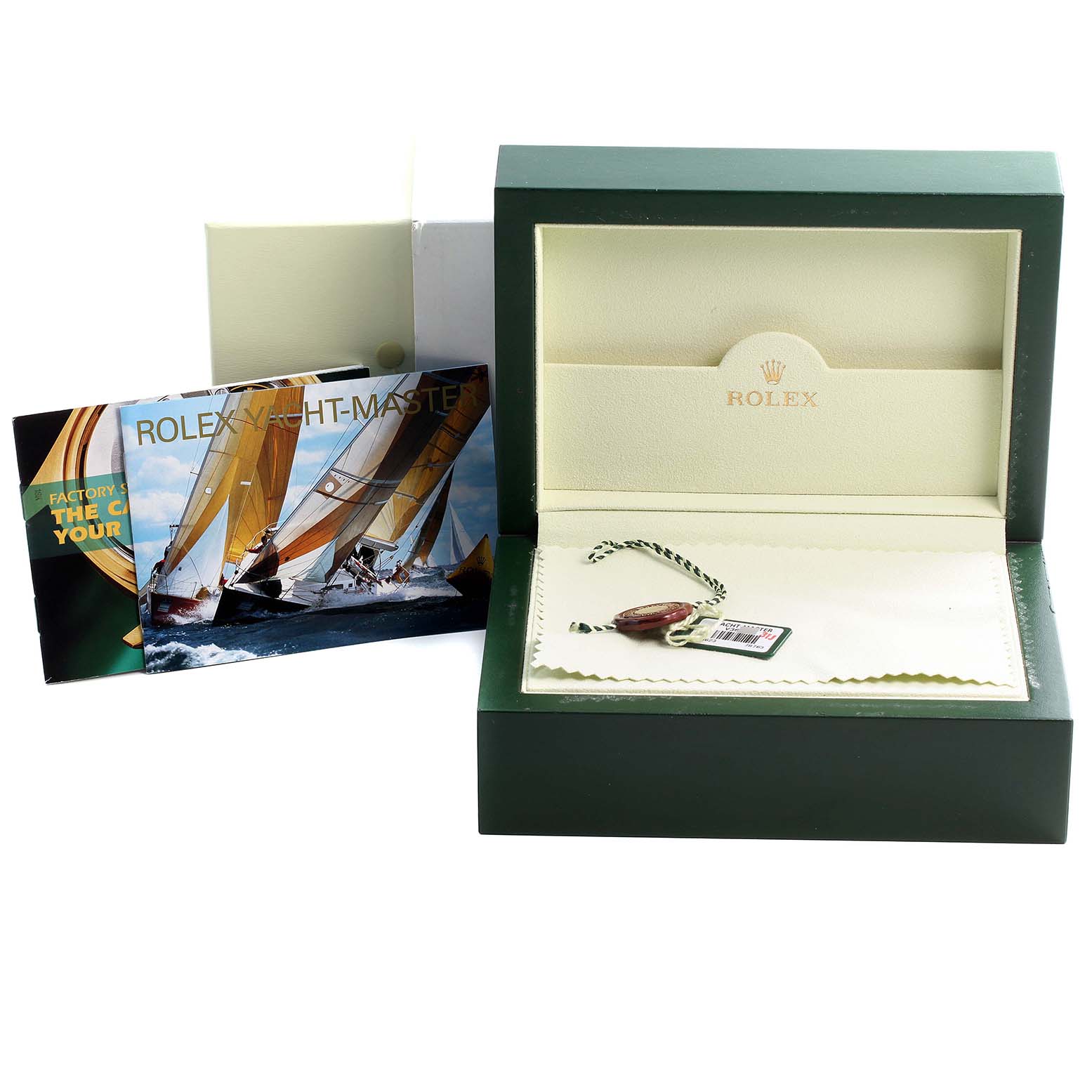 This image shows an open Rolex Yacht-Master 16623 Men's Steel and Gold (two tone) Blue Dial 16623 Men's Steel and Gold (two tone) Blue Dial watch box with booklets and tags placed beside it.