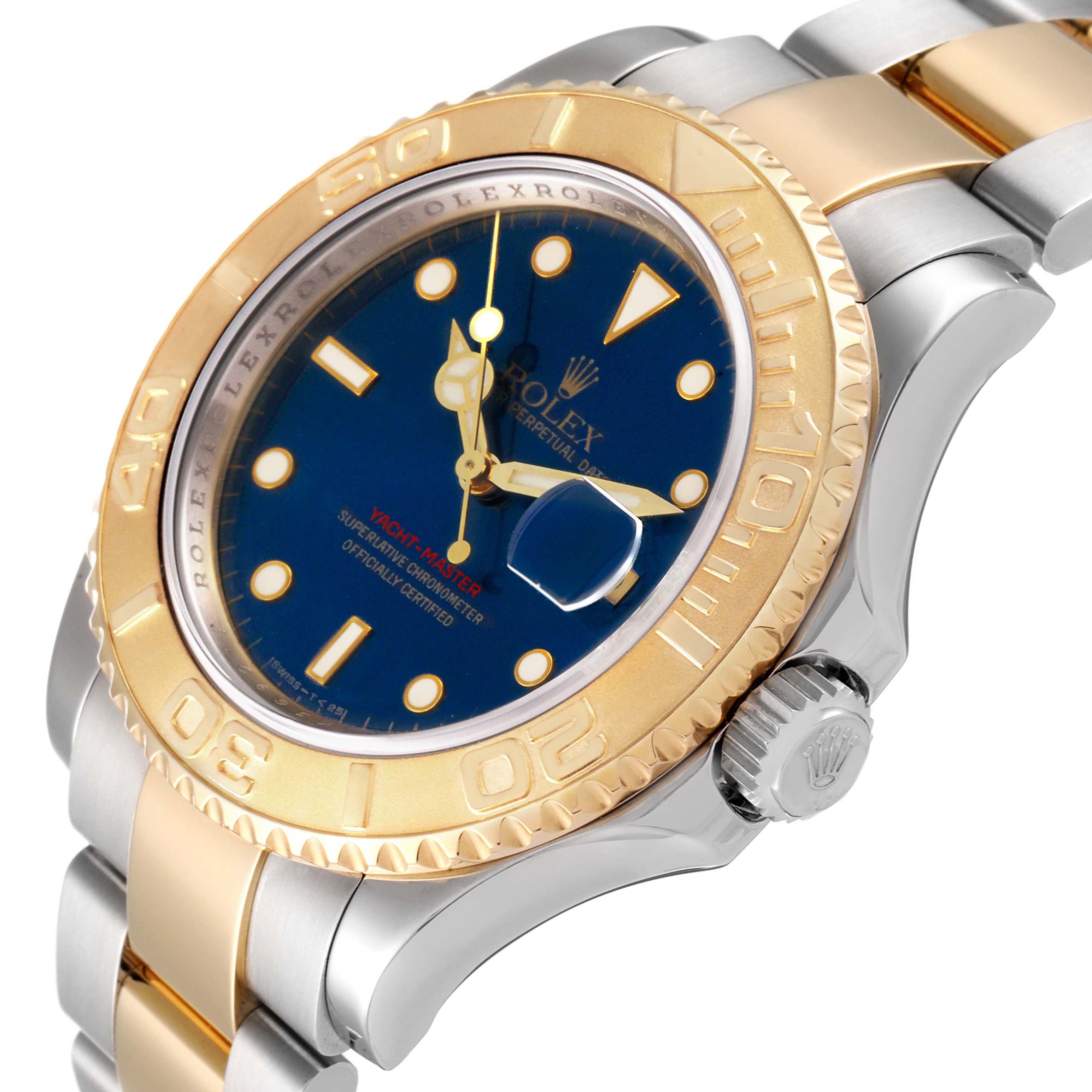 The image shows a close-up of the Rolex Yacht-Master 16623 Men's Steel and Gold (two tone) Blue Dial 16623 Men's Steel and Gold (two tone) Blue Dial watch, highlighting its bezel, crown, bracelet, and dial.