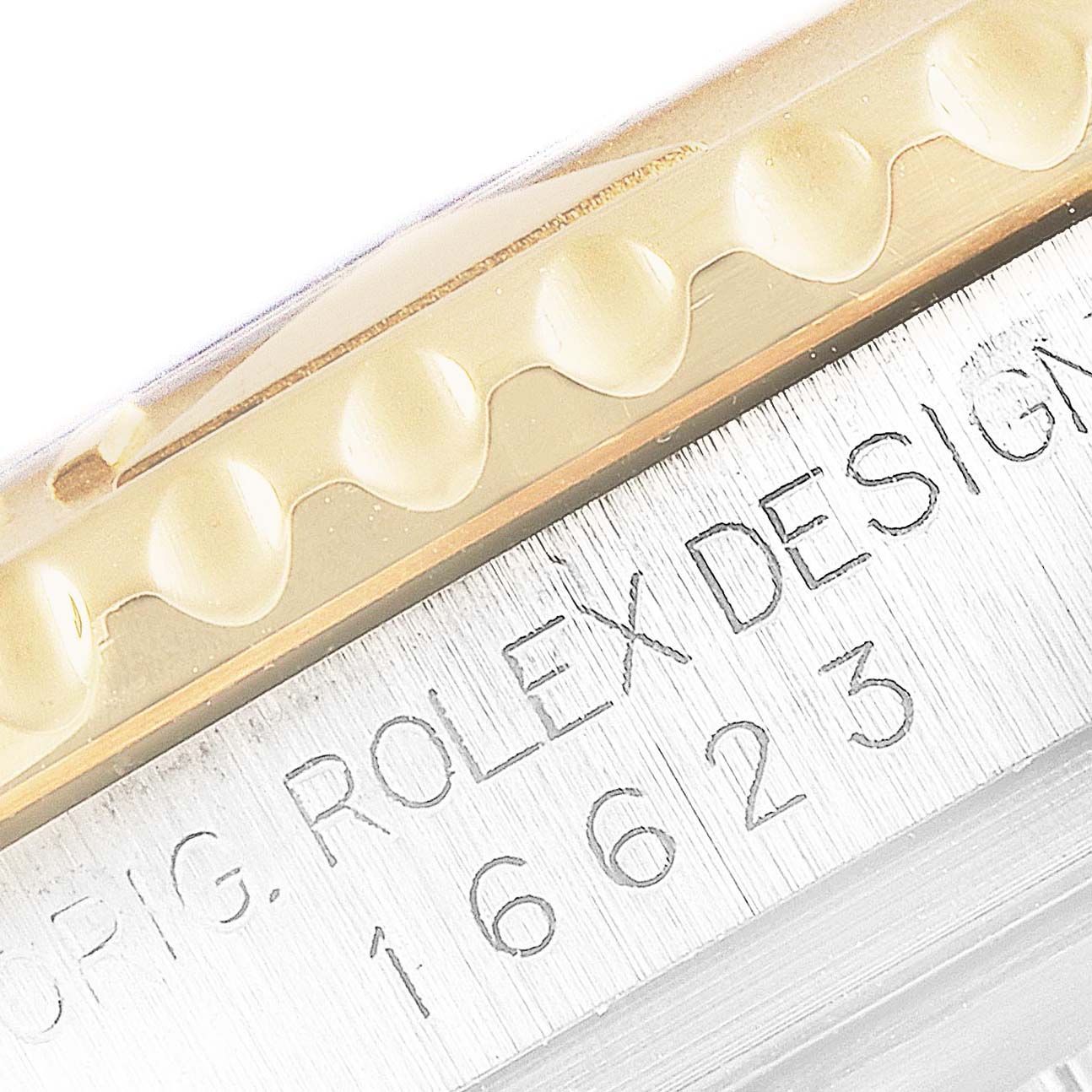 The image shows a close-up of the engraved bezel and serial number on a Rolex Yacht-Master 16623 Men's Steel and Gold (two tone) Mother of Pearl Dial 16623 Men's Steel and Gold (two tone) Mother of Pearl Dial watch.