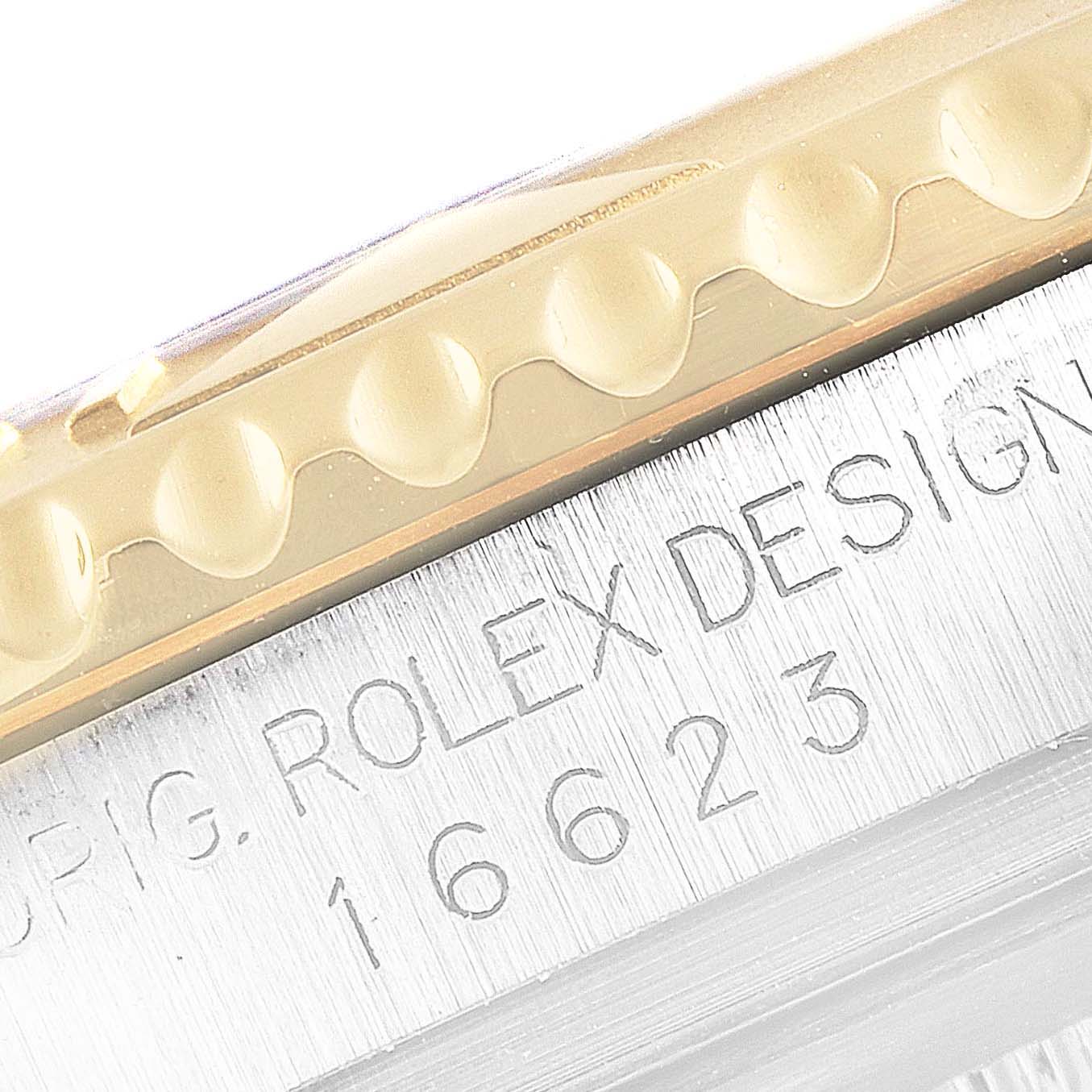 This close-up image shows the engraved casing and the edge of the bezel of the Rolex Yacht-Master 16623 Men's Steel and Gold (two tone) White Dial 16623 Men's Steel and Gold (two tone) White Dial watch.