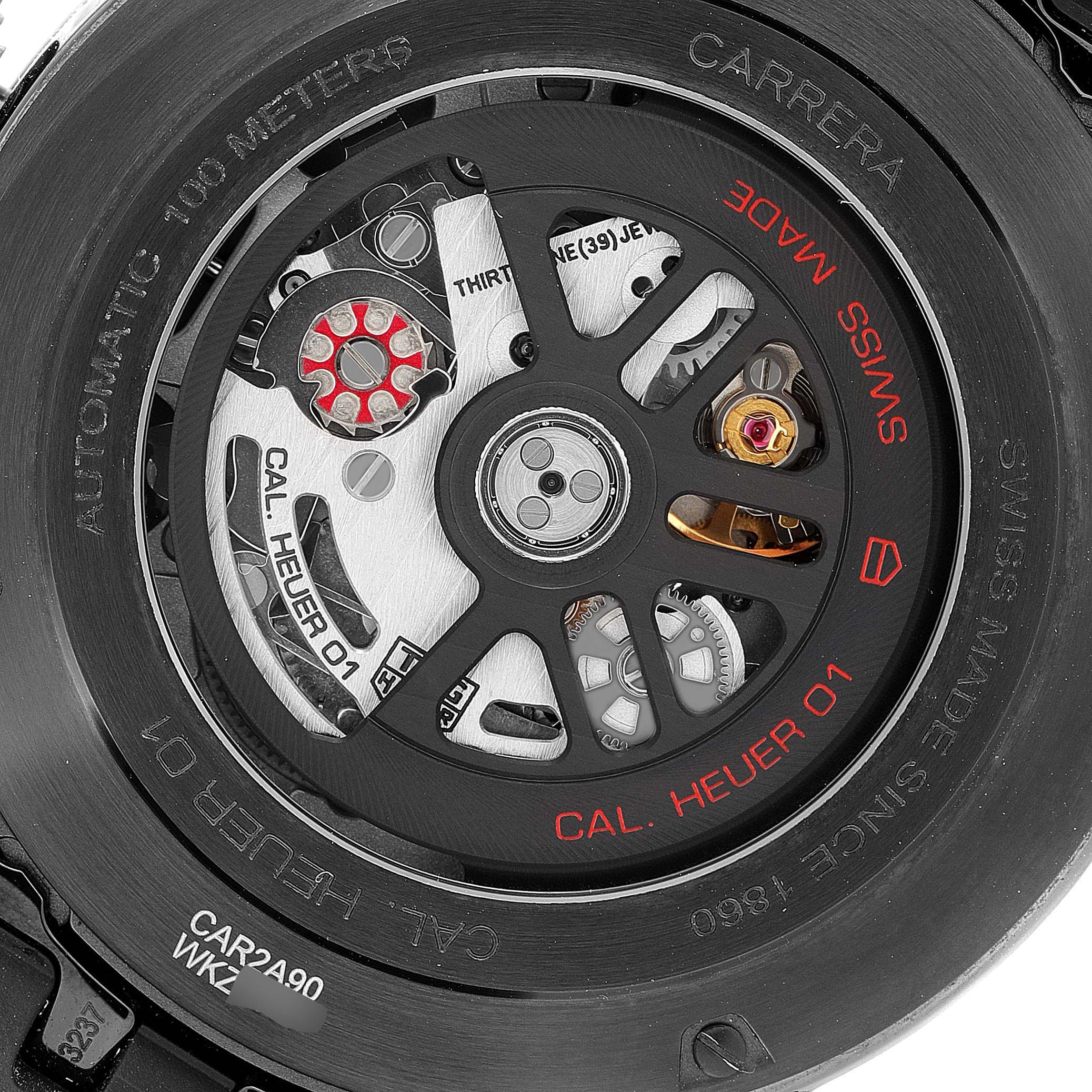 The image shows the back view of the Tag Heuer Carrera CAR2A90.FT6071 Men's Ceramic Black Dial CAR2A90.FT6071 Men's Ceramic Black Dial watch, highlighting its intricate movement and "Cal. Heuer 01" inscription.