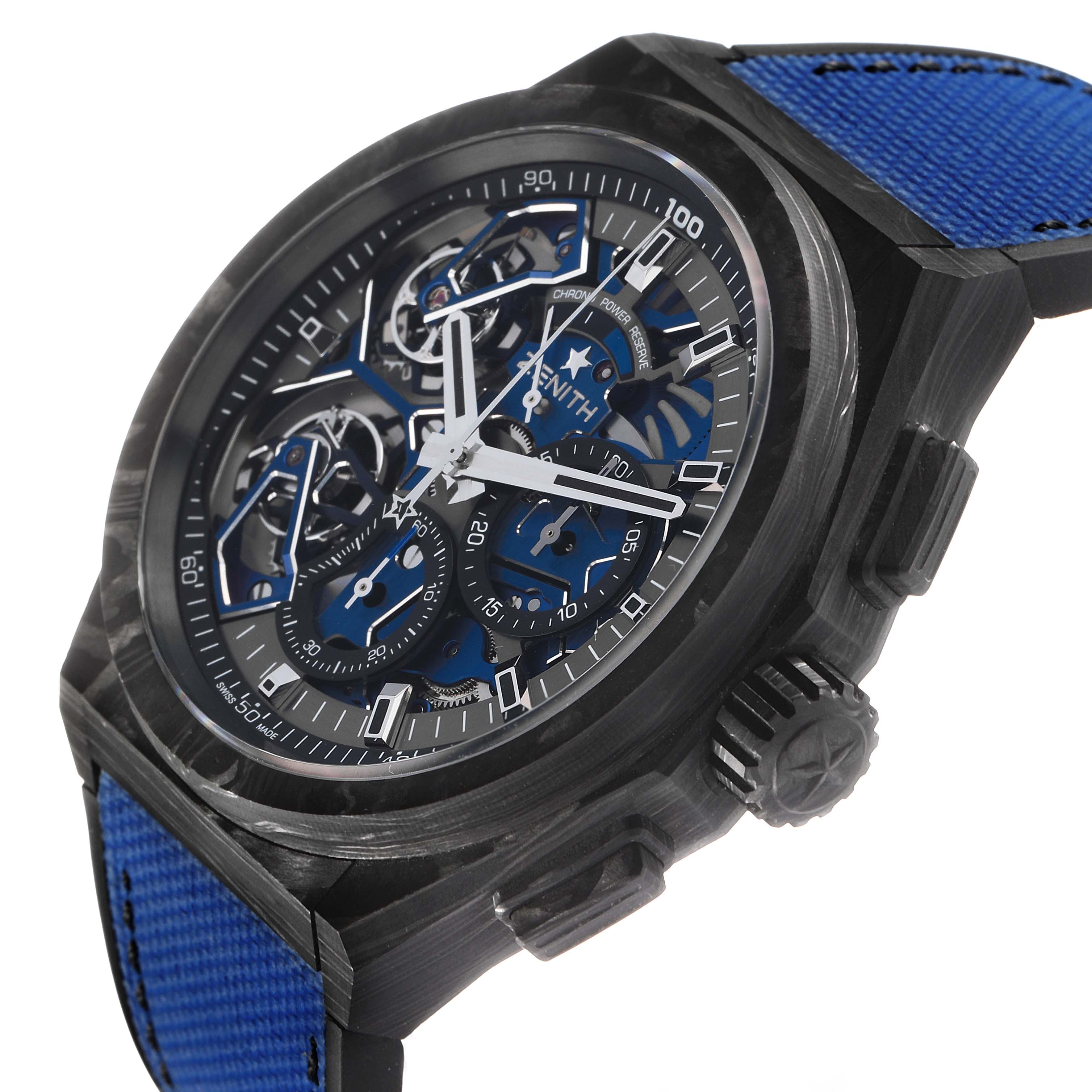 The Zenith Defy 10.9000.9020/79.R918 Men's Titanium Blue Dial watch is angled to show the face, crown, and blue strap, highlighting its intricate details and skeleton design.