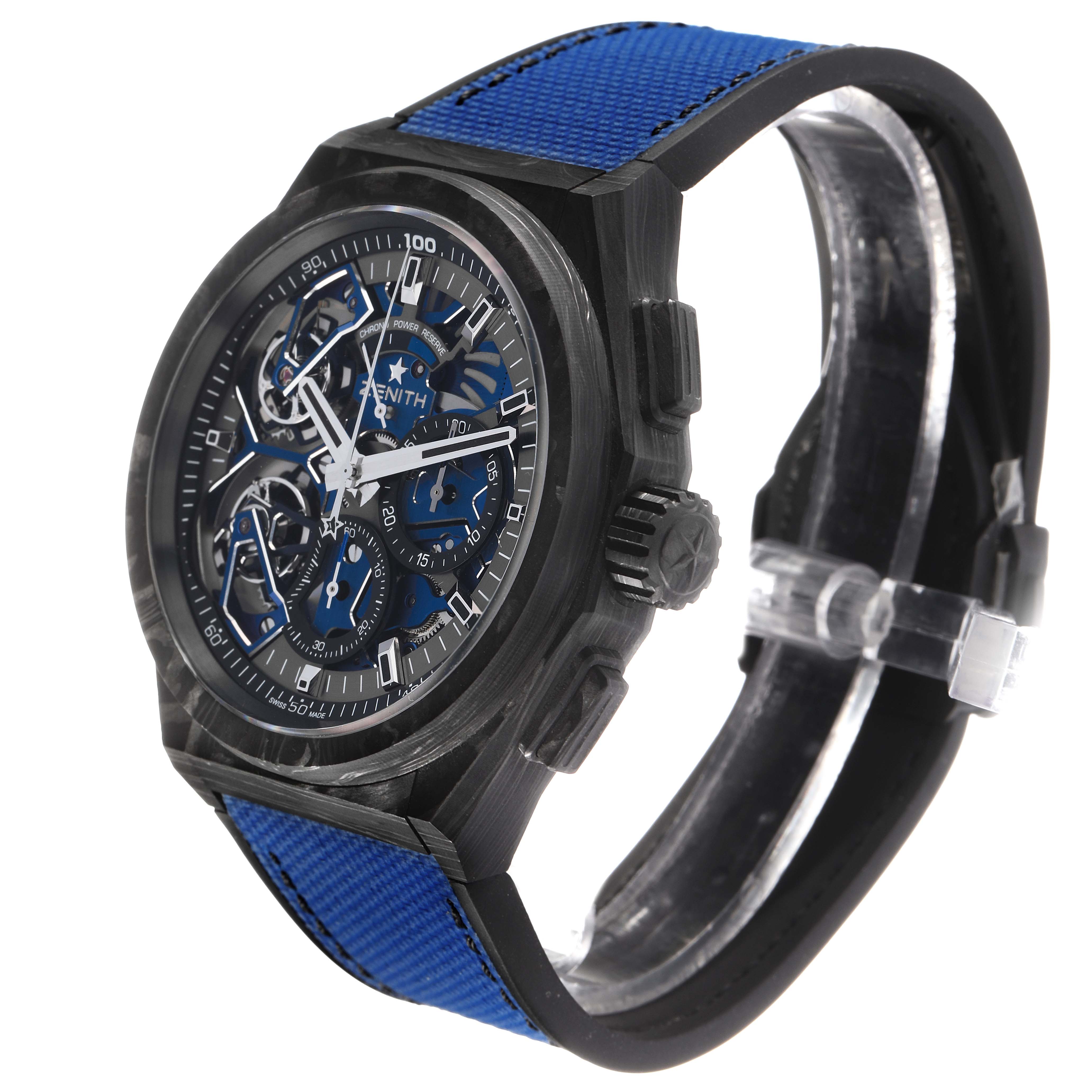 The Zenith Defy 10.9000.9020/79.R918 Men's Titanium Blue Dial watch is shown from an angled side view, highlighting the face, case, crown, and blue strap.