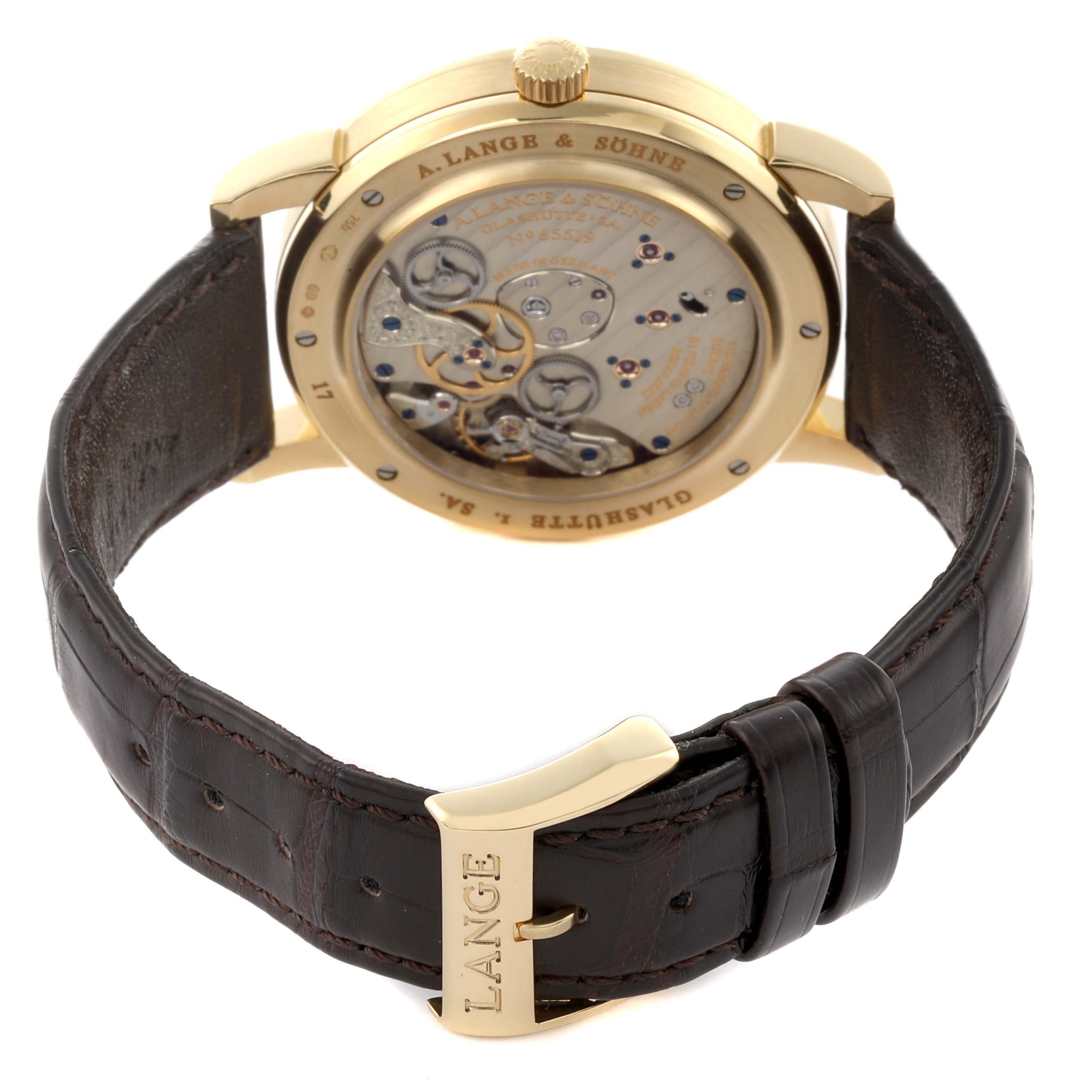 The image shows a rear view of the A. Lange 
Sohne Lange 1 116.021 Men
s Yellow Gold Silver Dial, highlighting its movement and brown leather strap.