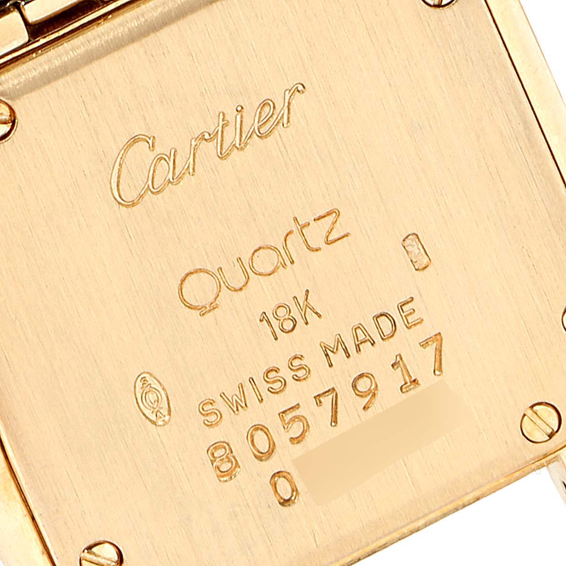 This is the back view of a Cartier Panthère watch, highlighting its engravings indicating it
s quartz, 18K gold, and Swiss-made.