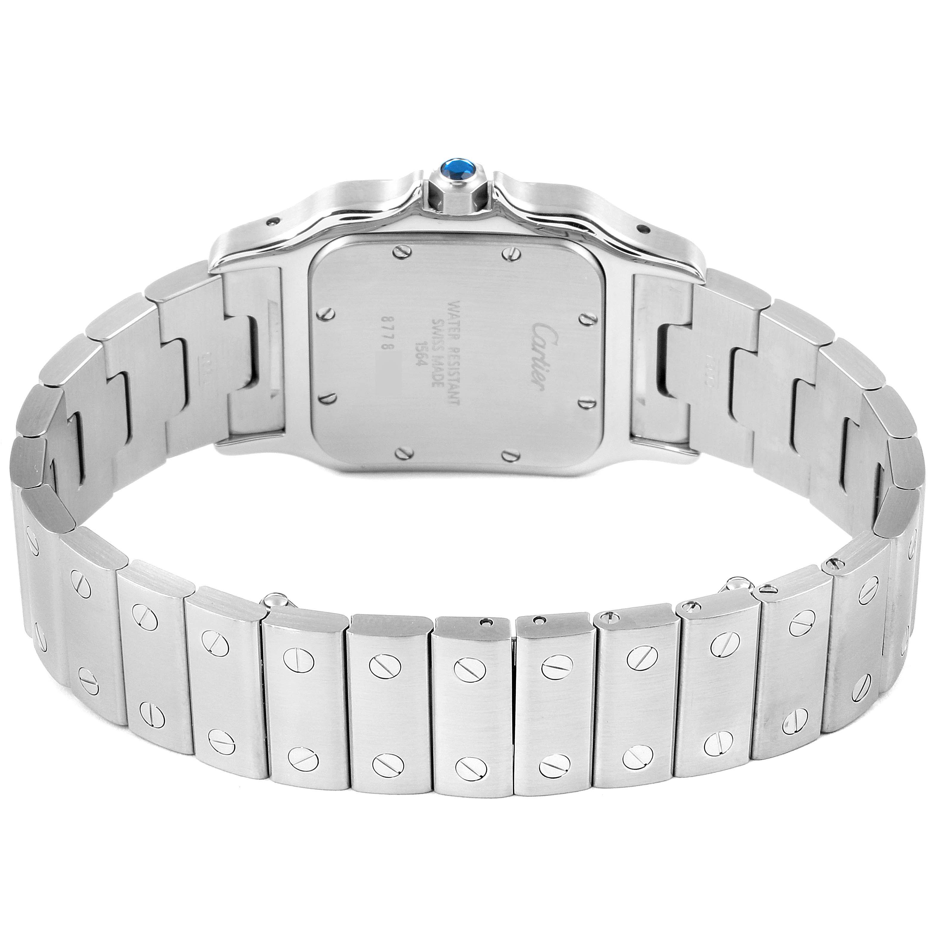 The image shows the back view of a Santos model by Cartier, focusing on the caseback and stainless steel bracelet.