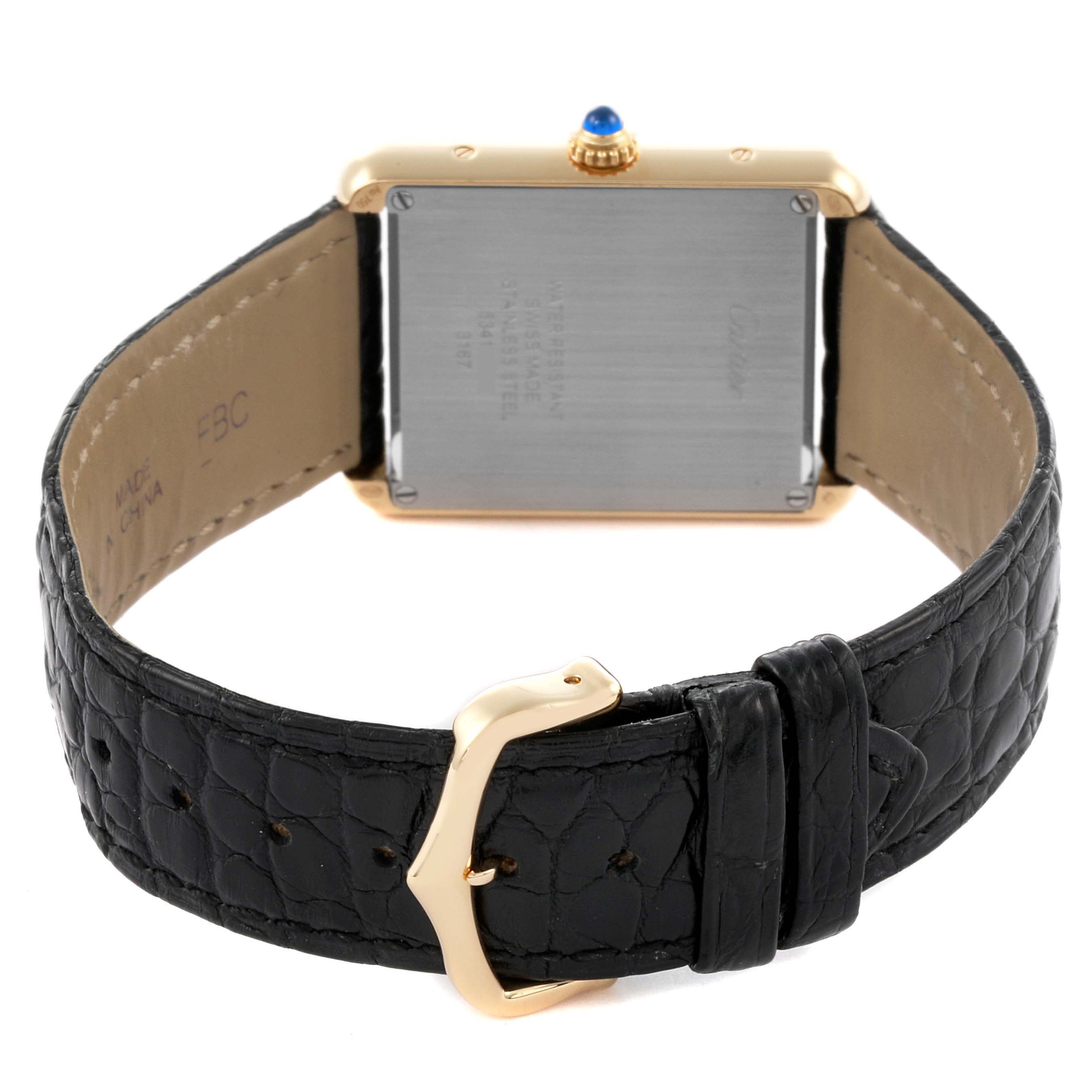 The image shows the back view of a Cartier Tank Solo W5200004 Men
s Steel and Gold (two tone) Silver Dial W5200004 Men
s Steel and Gold (two tone) Silver Dial watch, highlighting the buckle and leather strap.