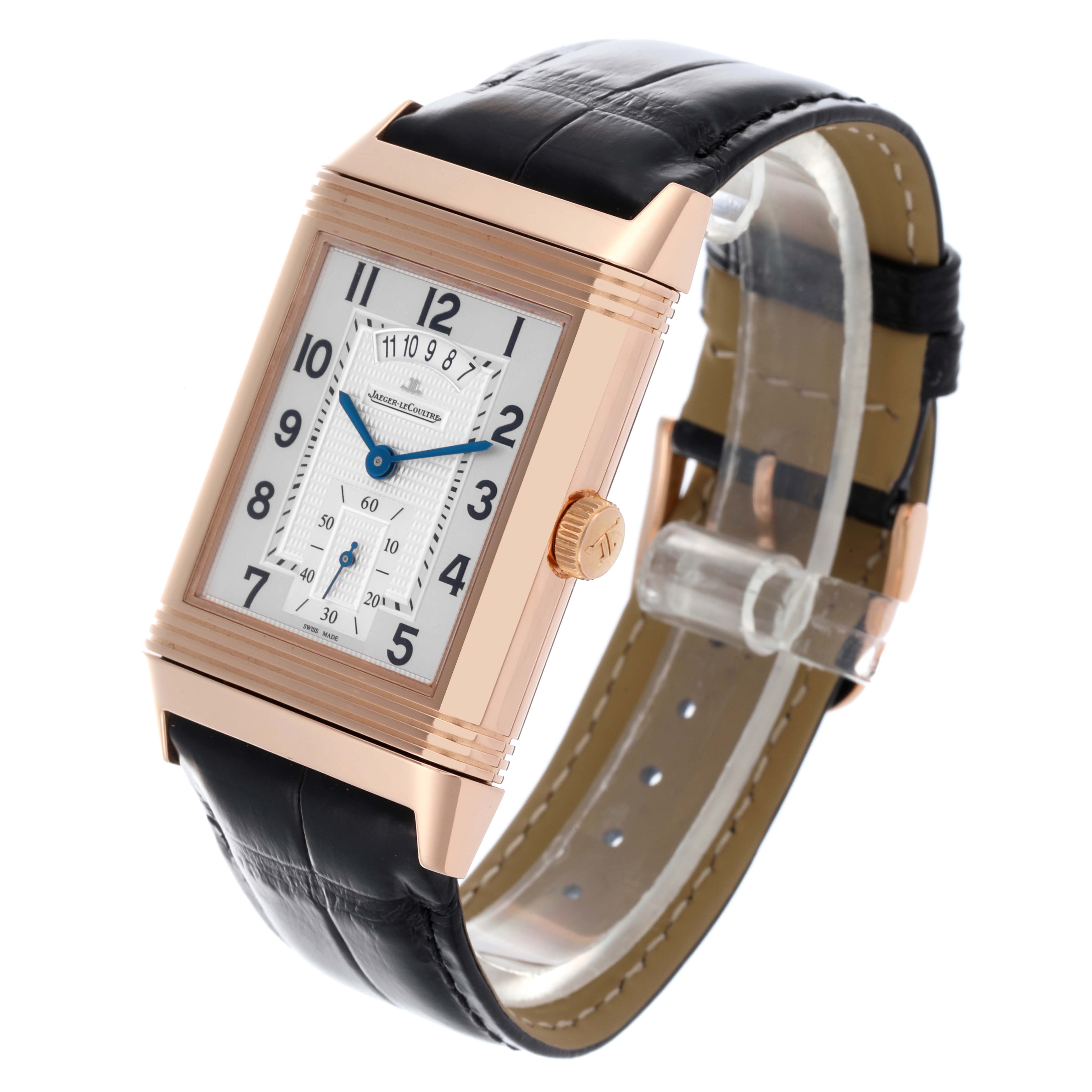 The Jaeger-LeCoultre Reverso watch is shown at a slight angle, highlighting the case, dial, and leather strap.