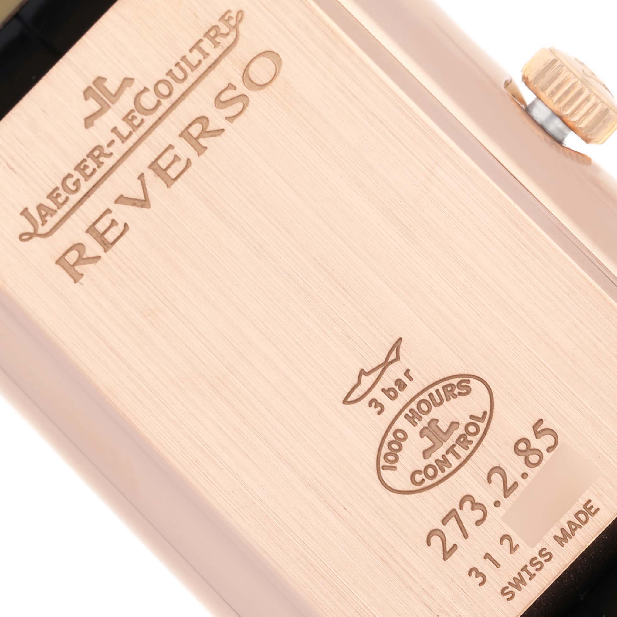 The image shows the back of a Jaeger-LeCoultre Reverso watch, highlighting branding and model details at an angle.