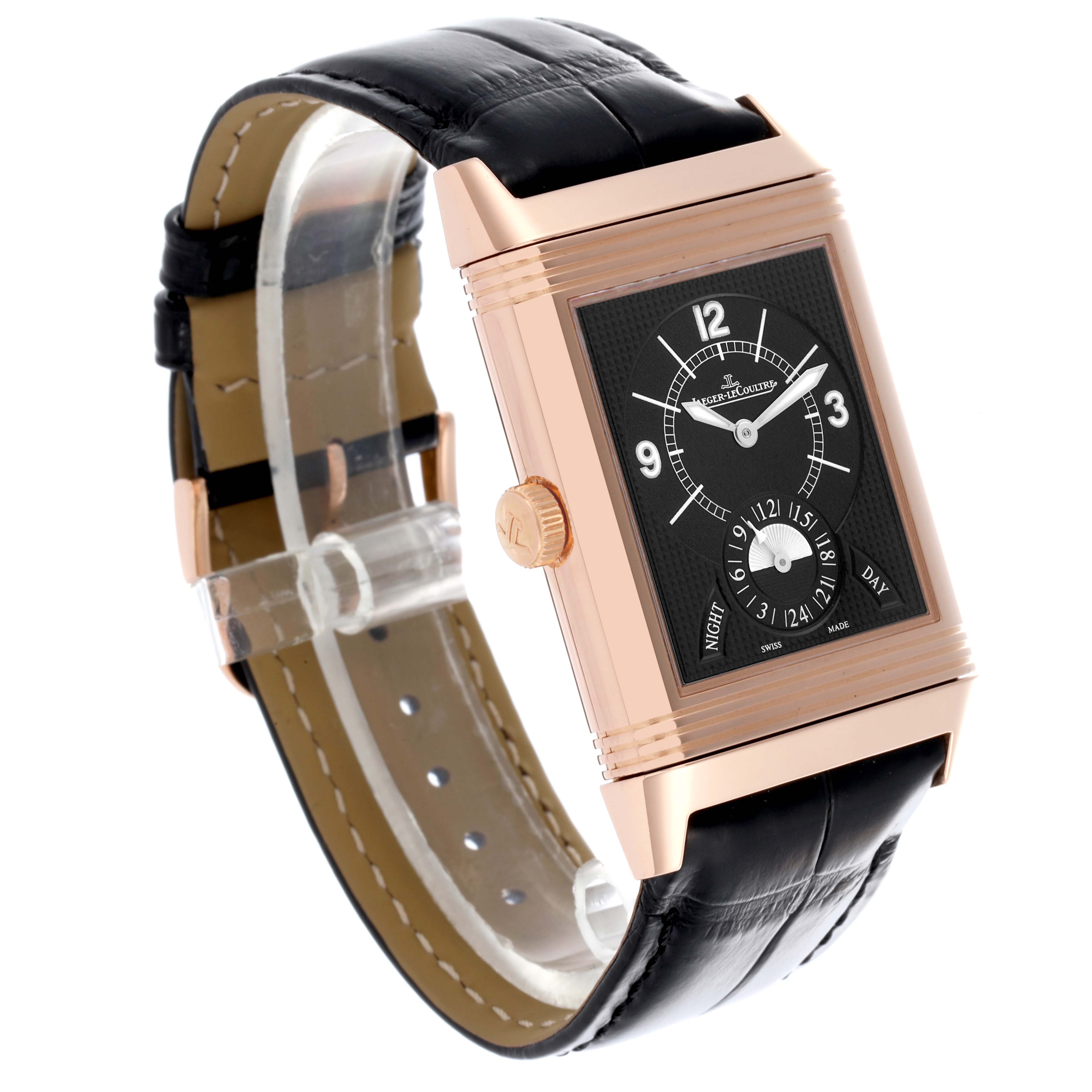The Jaeger-LeCoultre Reverso watch is shown at a three-quarter angle, displaying its face, crown, and leather strap.