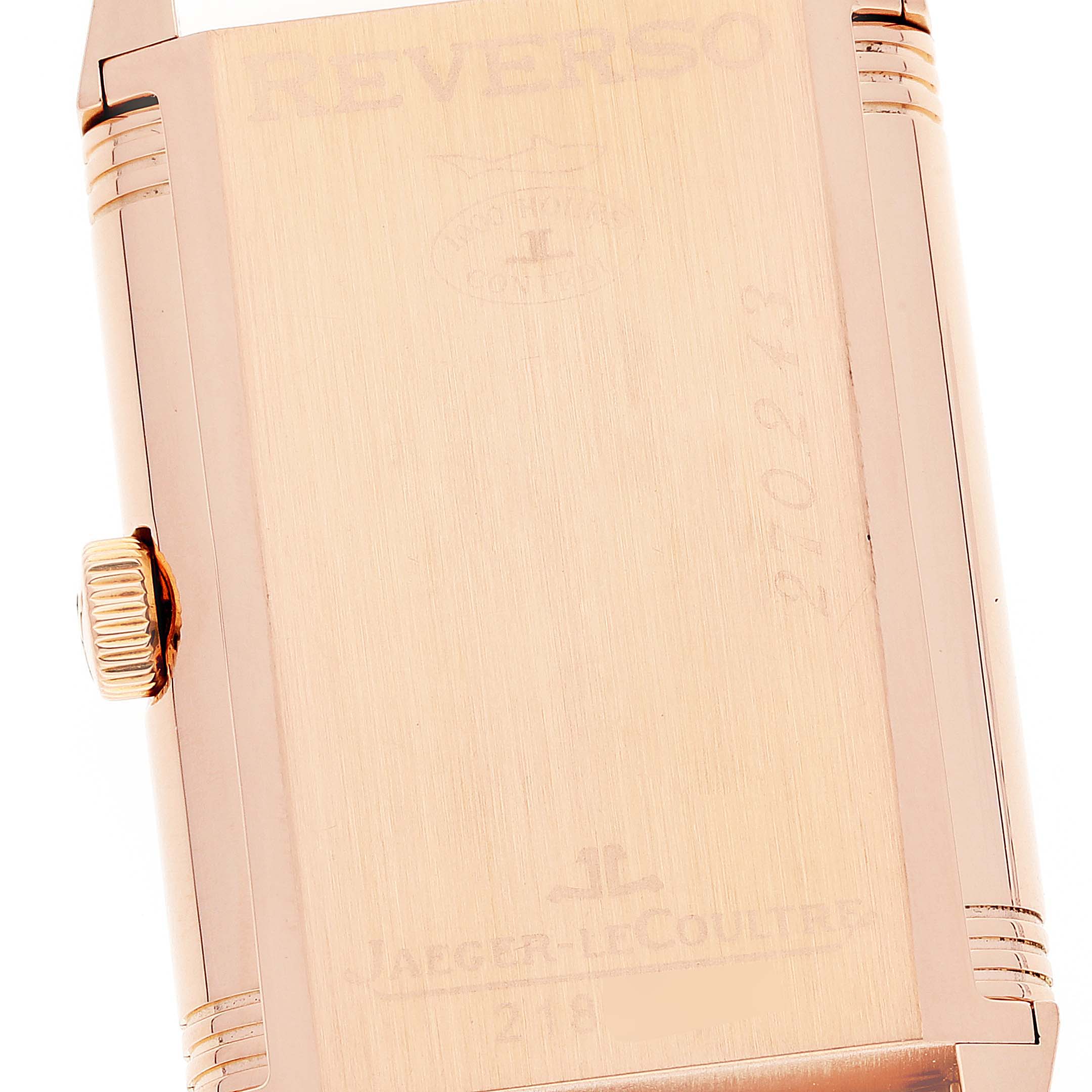 The image shows the back case of a Jaeger-LeCoultre Reverso watch, highlighting the crown and engravings.