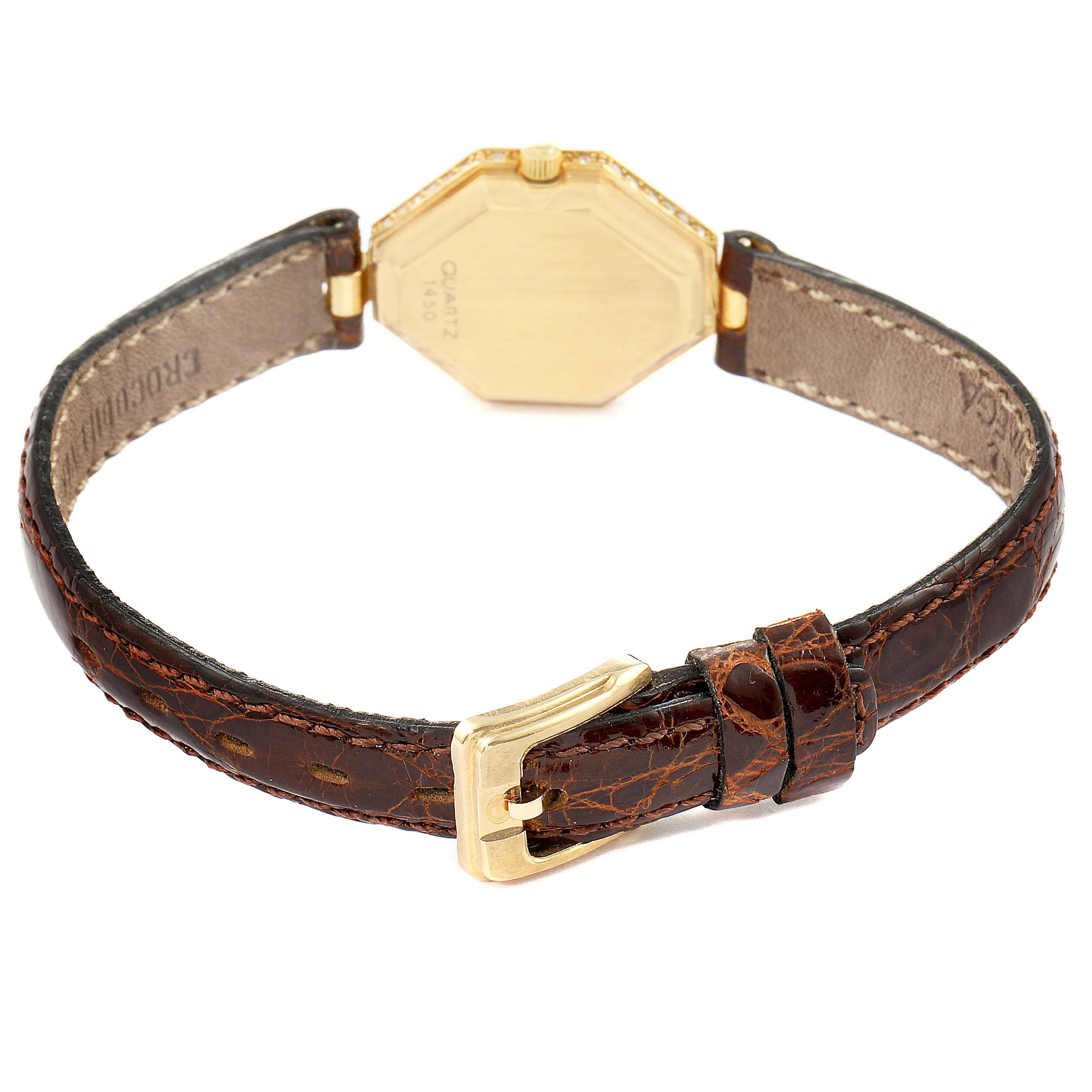 The image shows the back view of the Omega 1450 Women's Yellow Gold Champagne Dial 1450 Women's Yellow Gold Champagne Dial DeVille Mini Yellow Gold Diamond Cocktail Ladies Watch 1450 Unworn, featuring its caseback and leather strap with buckle.