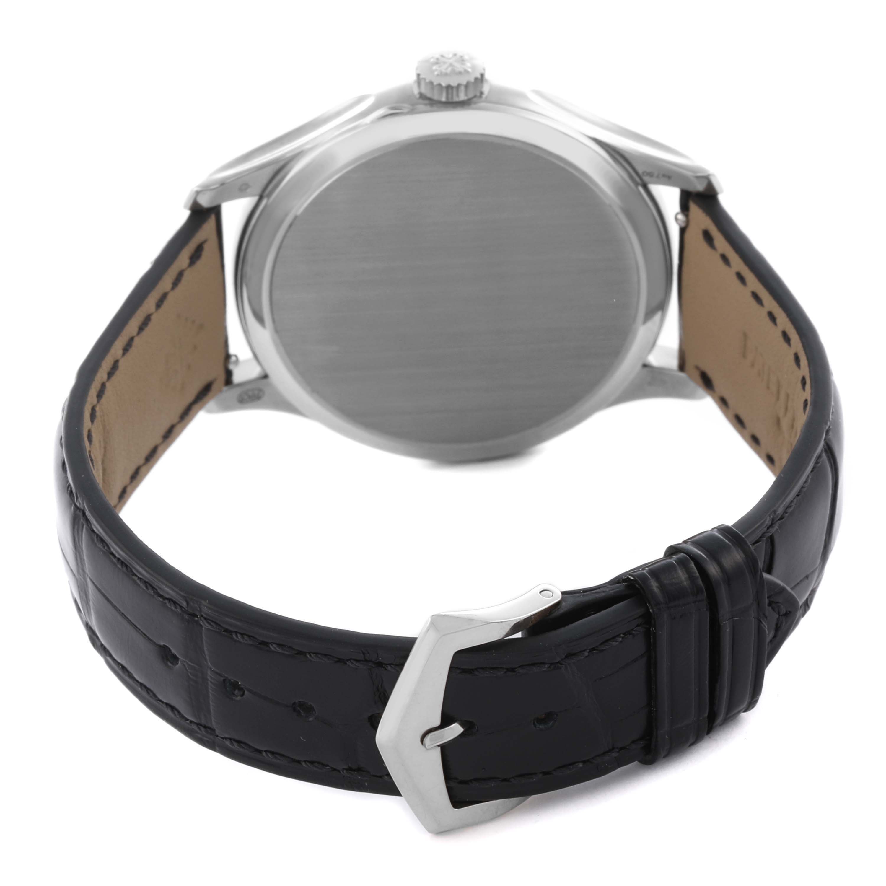 The Patek Philippe Calatrava 5227G-001 Men's White Gold Beige Dial 5227G-001 Men's White Gold Beige Dial watch is shown from the back, highlighting the case back, crown, and black leather strap with buckle.