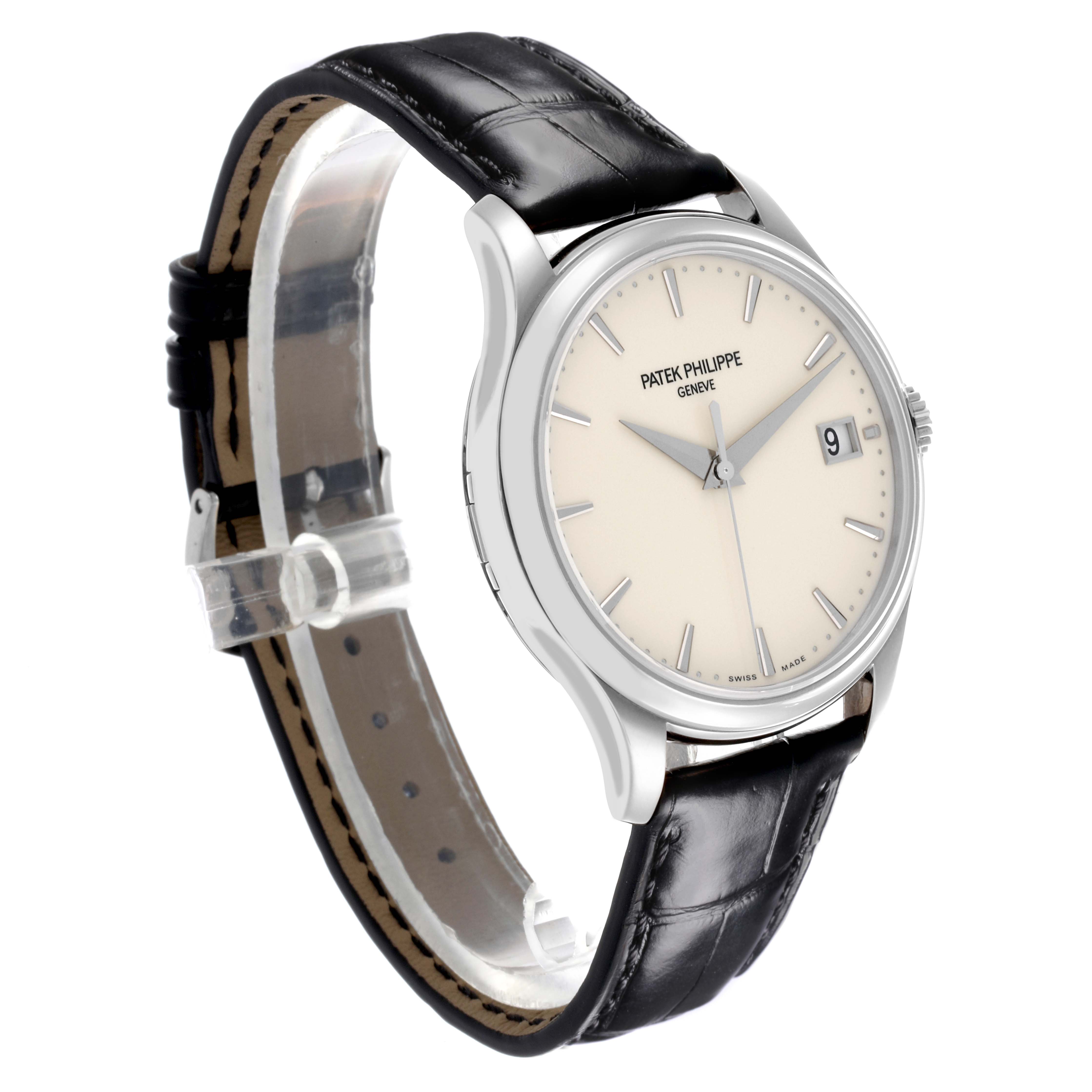 The Patek Philippe Calatrava 5227G-001 Men's White Gold Beige Dial 5227G-001 Men's White Gold Beige Dial watch is shown at a three-quarter angle, highlighting the face, case, and leather strap.