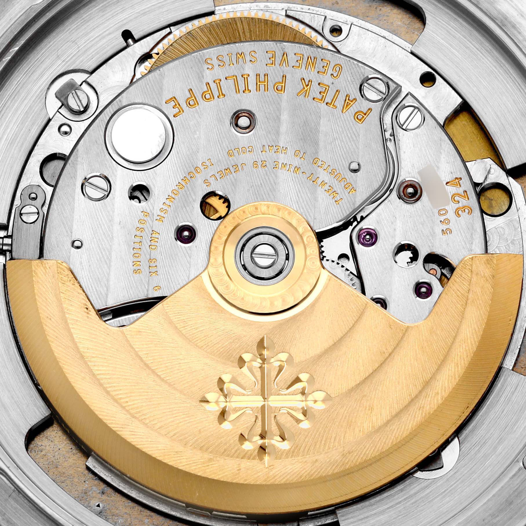 The image shows the movement of a Patek Philippe Calatrava 5227G-001 Men's White Gold Beige Dial 5227G-001 Men's White Gold Beige Dial watch, highlighting the automatic rotor and internal components.