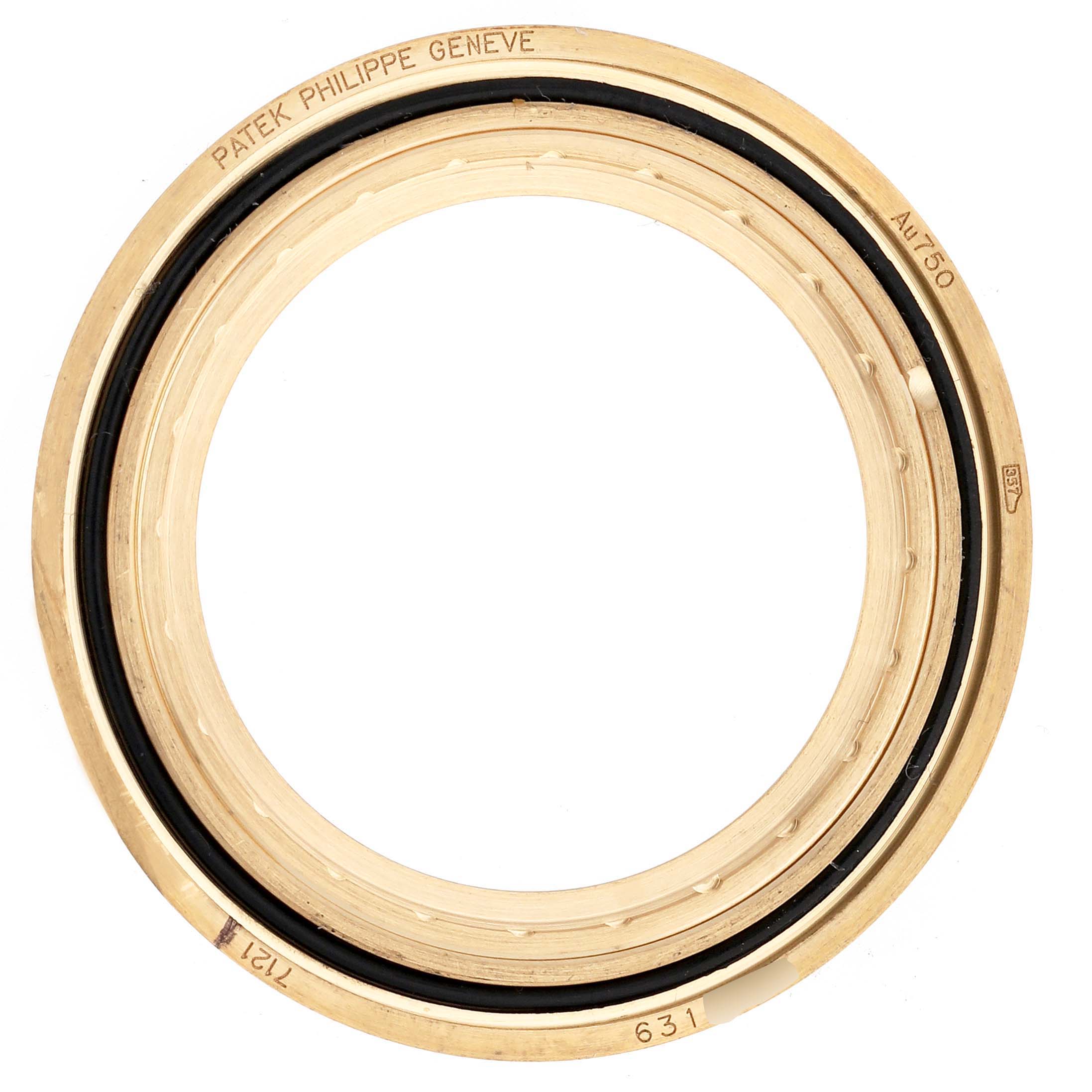 The image shows a gold bezel ring for the Patek Philippe Calatrava 7121J-001 Women's Yellow Gold Silver Dial, viewed from above with engraved markings visible.