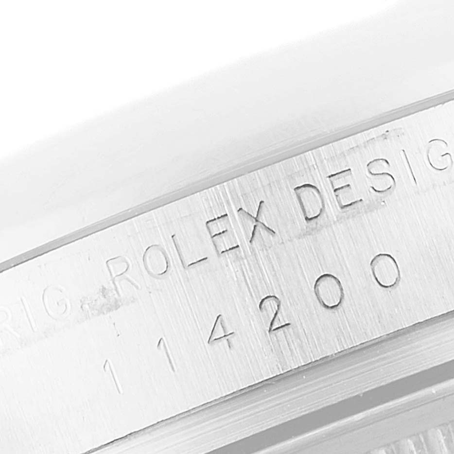 The image shows a close-up of the side engraving on the bezel of a Rolex Air-King 114200 Men's Stainless Steel Blue Dial 114200 Men's Stainless Steel Blue Dial watch with model number 114200.