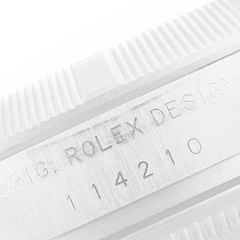 The image shows a close-up of the side engraving of a Rolex Air-King 114210 Men's Stainless Steel Blue Dial 114210 Men's Stainless Steel Blue Dial watch, featuring the model number 114210.