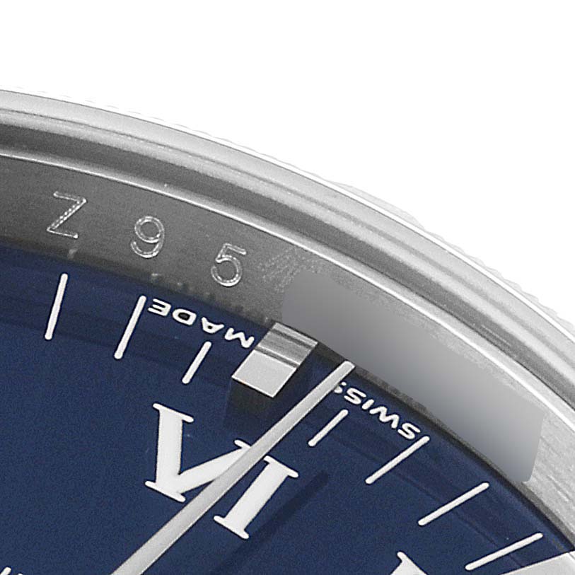 Close-up of the dial of a Rolex Air-King 114210 Men's Stainless Steel Blue Dial 114210 Men's Stainless Steel Blue Dial watch, showing part of the Roman numeral VI, minute markers, and bezel.