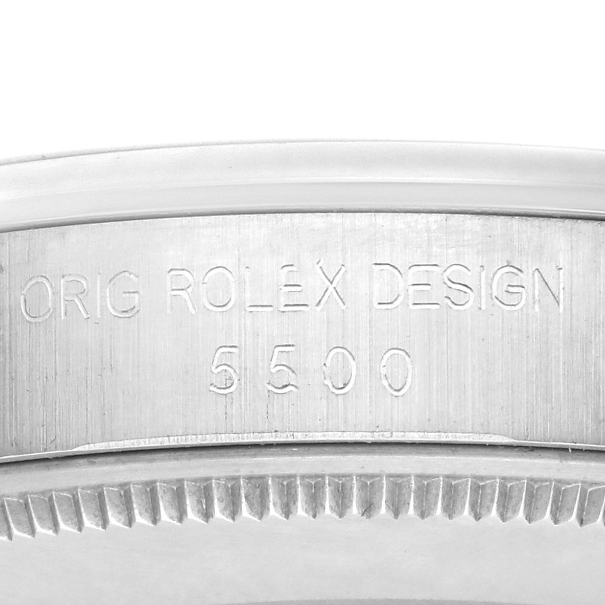 This image shows a close-up of the side of the Rolex Air-King 5500 Men's Stainless Steel Silver Dial 5500 Men's Stainless Steel Silver Dial model, featuring engraved text and bezel details.