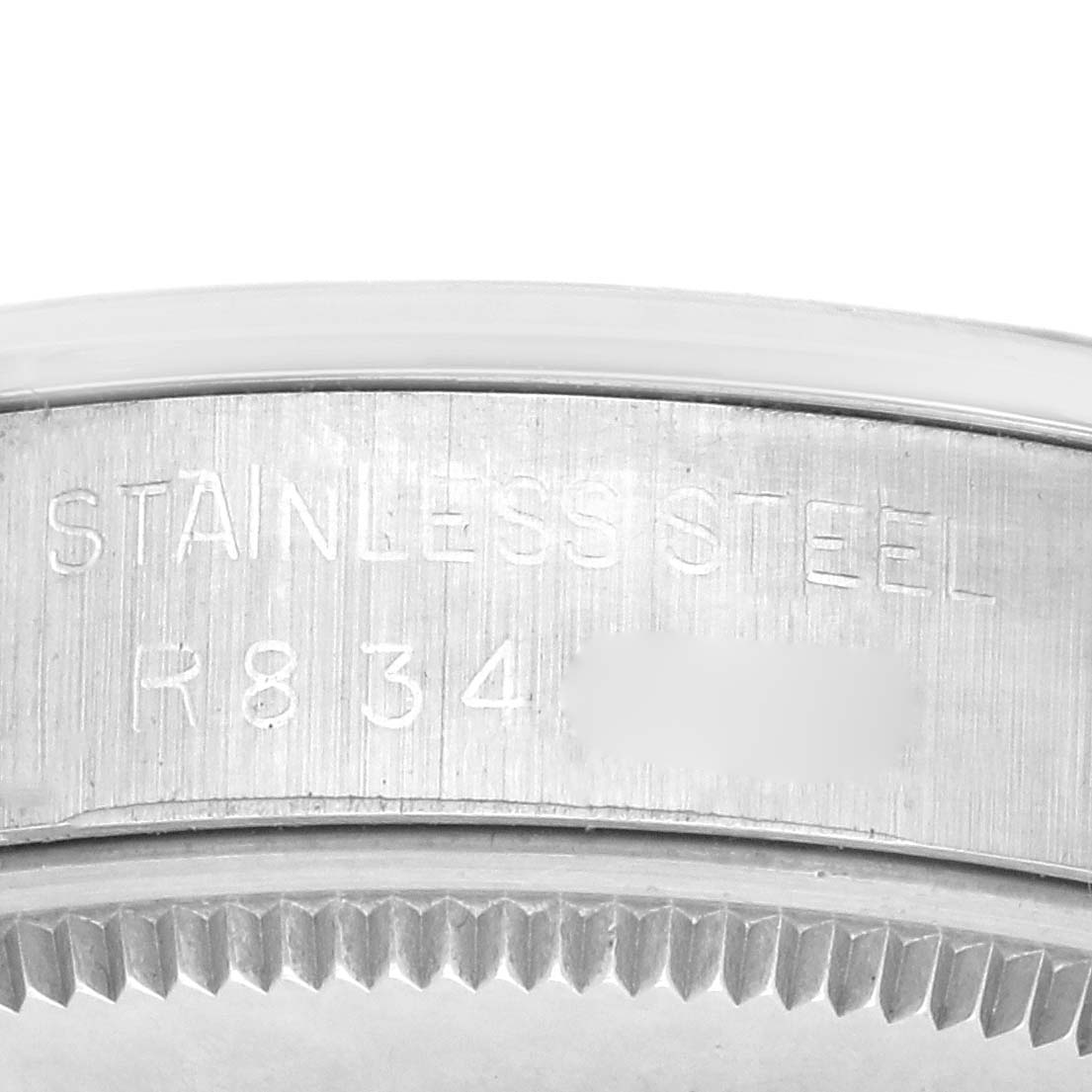The image shows an engraving on the side of a Rolex Air-King 5500 Men's Stainless Steel Silver Dial 5500 Men's Stainless Steel Silver Dial, displaying "STAINLESS STEEL" and a model reference.