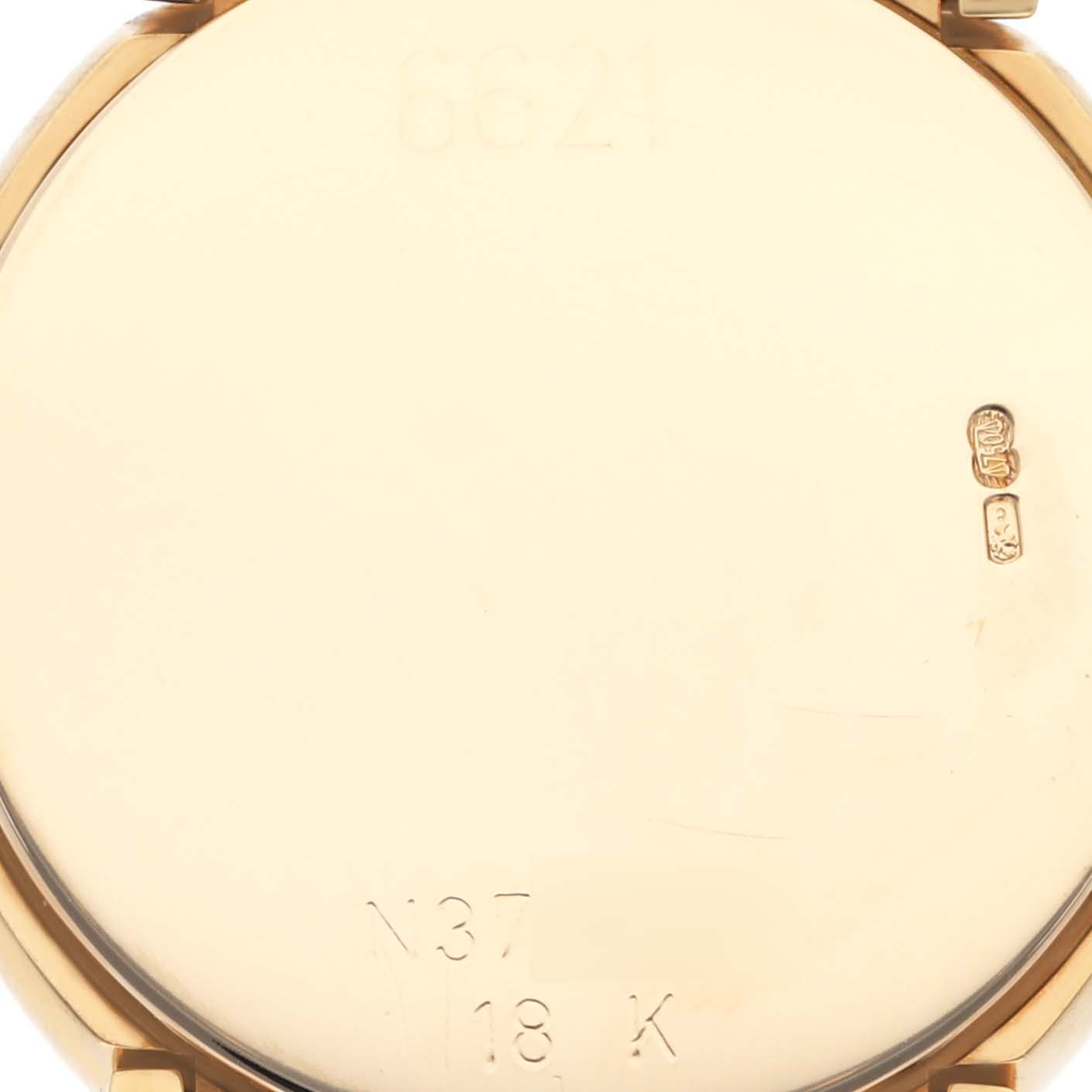 The image shows the back of a Rolex Cellini 6621 Women's Yellow Gold White Dial 6621 Women's Yellow Gold White Dial watch case, displaying engravings and hallmarks.