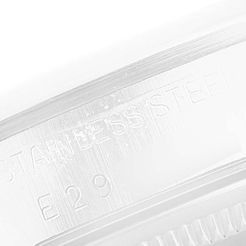 This image shows a close-up angle of the stainless steel case side of a Rolex Date 15200 Men's Stainless Steel White Dial 15200 Men's Stainless Steel White Dial model watch with some engraved text.