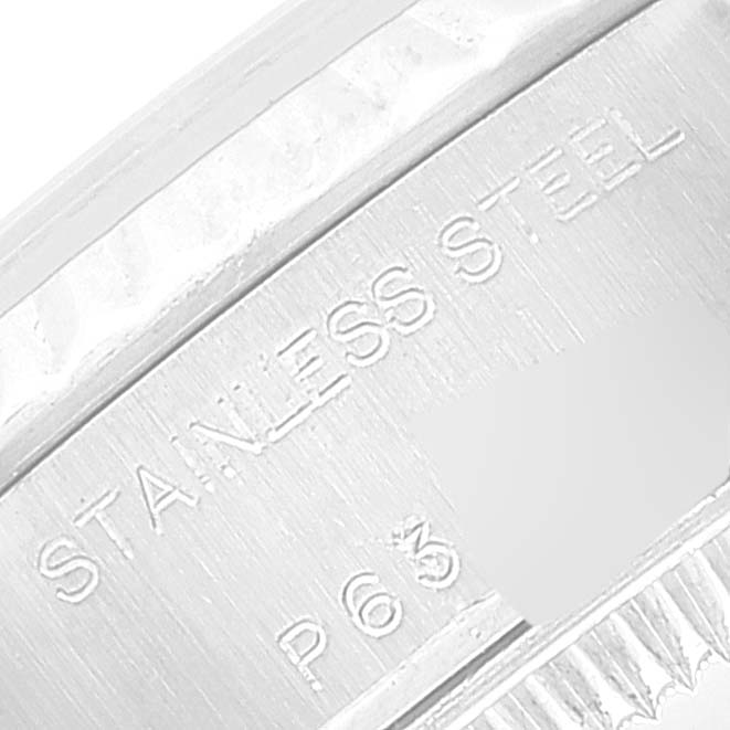 The image shows a close-up of the side of a Rolex Datejust 79174 Women's Stainless Steel Mother of Pearl Dial 79174 Women's Stainless Steel Mother of Pearl Dial model, highlighting the "STAINLESS STEEL" engraving.