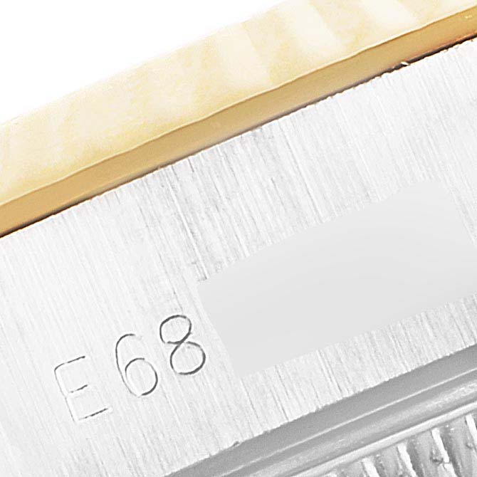 This image shows a close-up of the serial number engraving and part of the bezel of a Rolex Datejust 69173 Women
s Steel and Gold (two tone) Champagne Dial 69173 Women
s Steel and Gold (two tone) Champagne Dial watch.