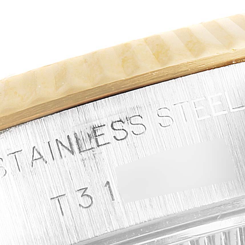 This close-up image shows the engraved stainless steel caseback and part of the bezel of a Rolex Datejust 69173 Women's Steel and Gold (two tone) Champagne Dial 69173 Women's Steel and Gold (two tone) Champagne Dial watch.