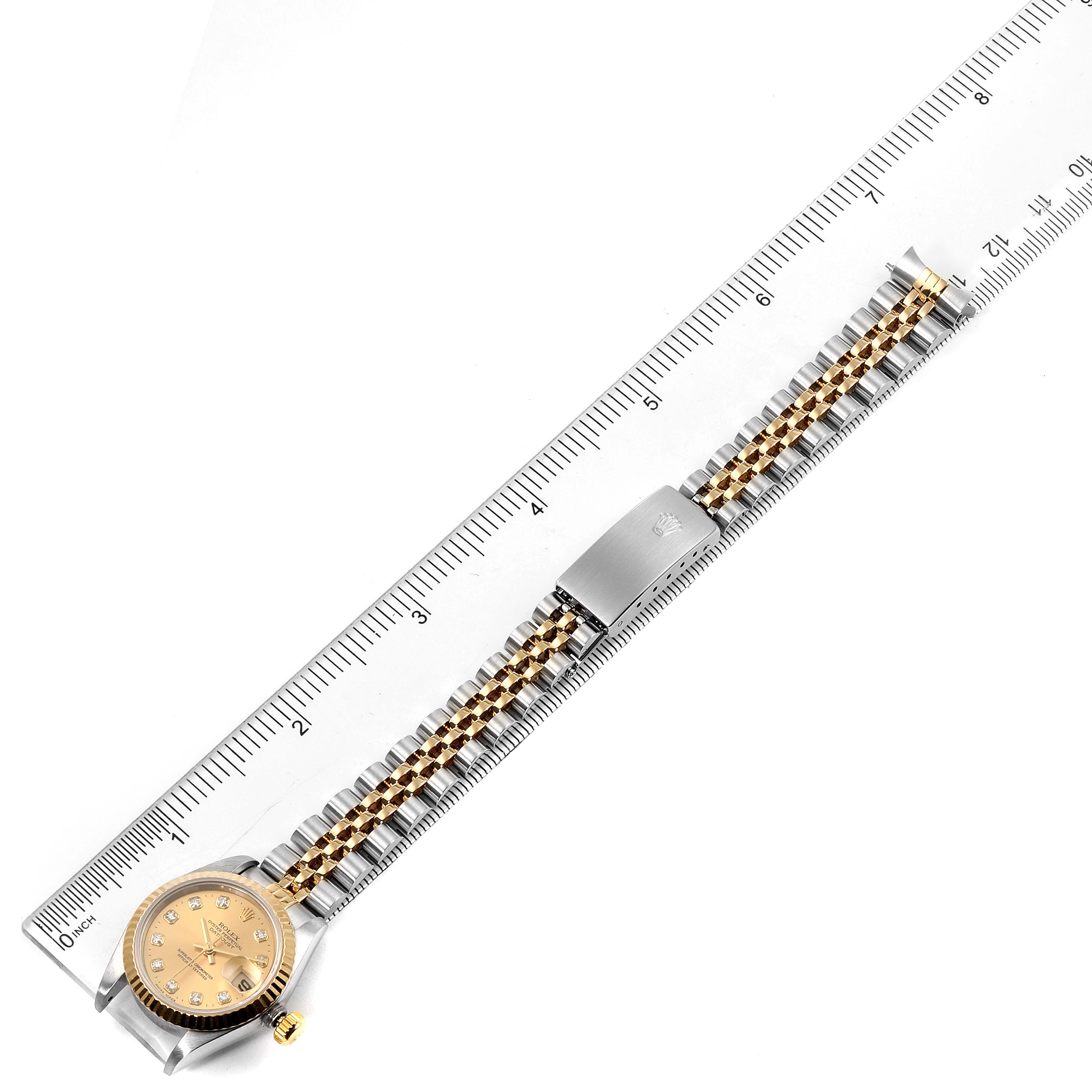 The image shows a top-down view of a Rolex Datejust 69173 Women's Steel and Gold (two tone) Champagne Dial 69173 Women's Steel and Gold (two tone) Champagne Dial watch alongside a ruler, highlighting the entire bracelet and dial.