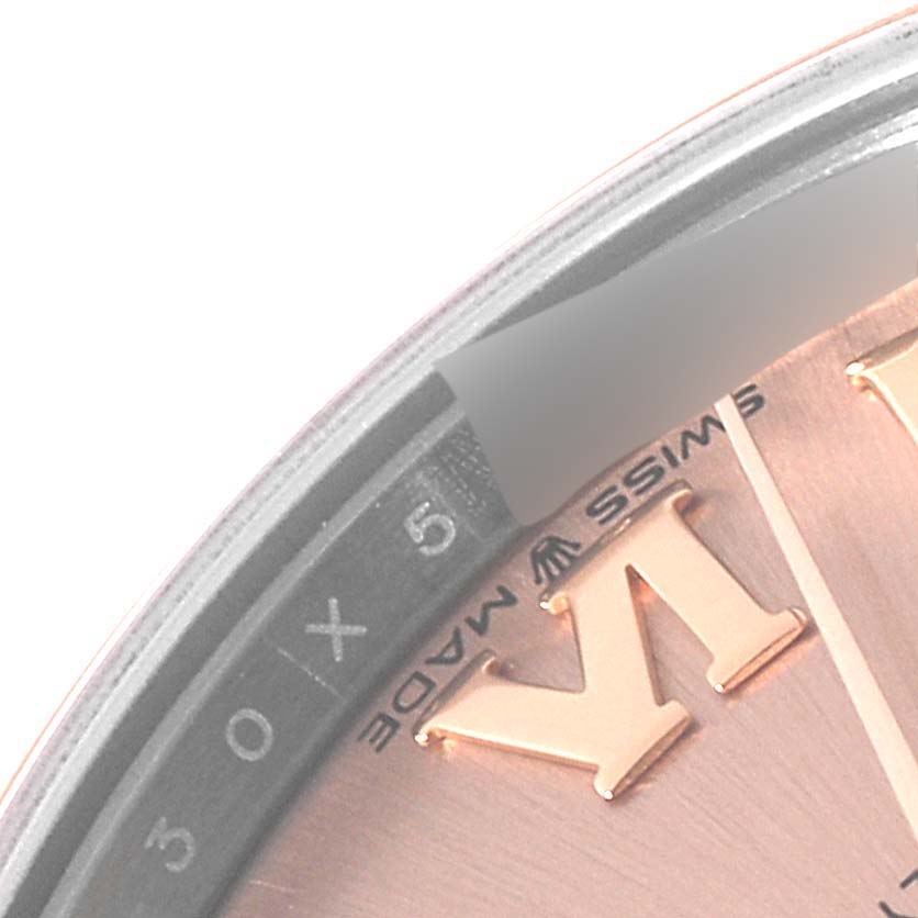This close-up image of a Rolex Mid-Size 278241 Women's Steel and Gold (two tone) Pink Dial 278241 Women's Steel and Gold (two tone) Pink Dial model watch shows a partial view of the watch face, including Roman numerals and "Swiss Made" text.