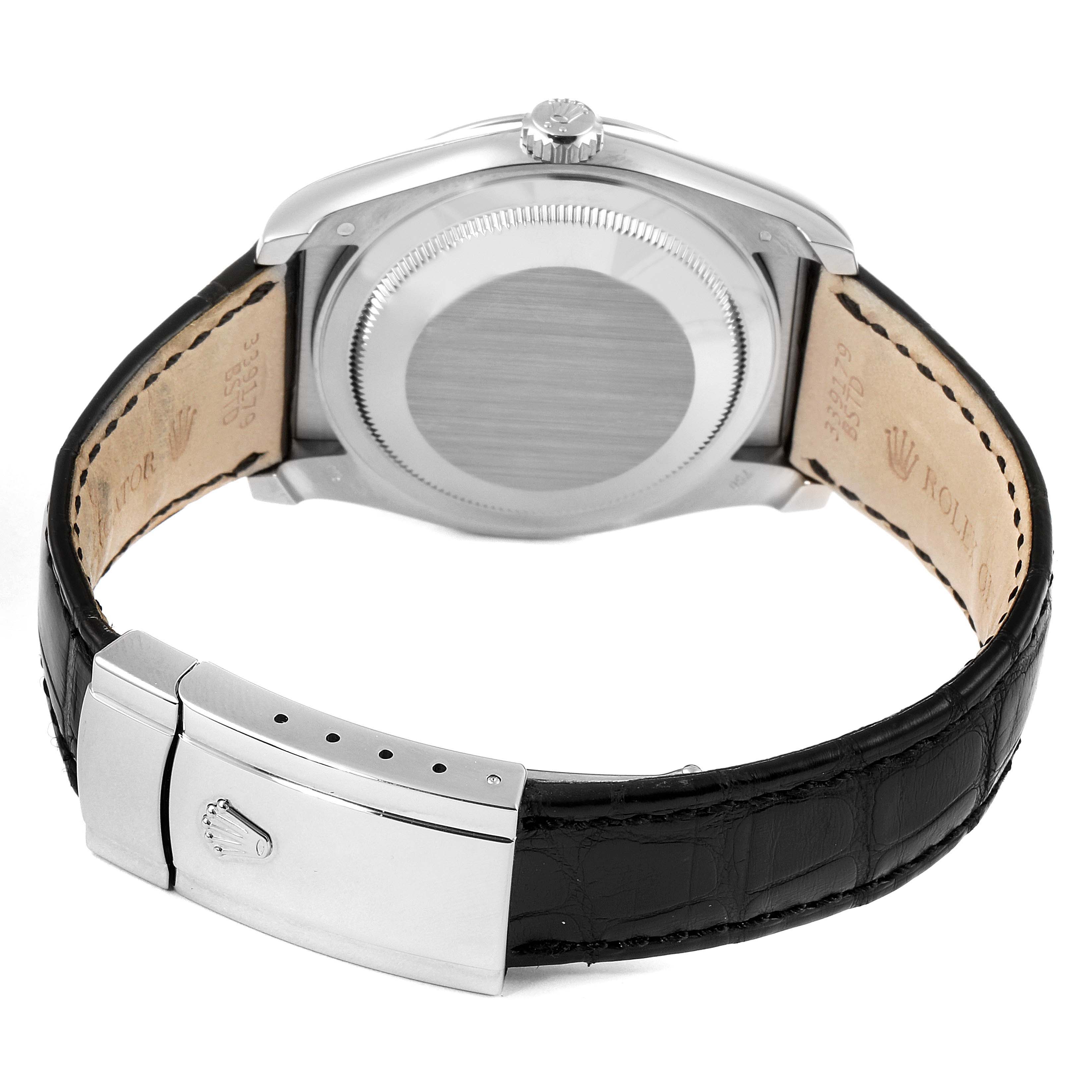The image shows the back view of a Rolex Datejust 116139 Men
s White Gold Silver Dial 116139 Men
s White Gold Silver Dial watch, highlighting its case back, crown, and clasps on the leather strap.